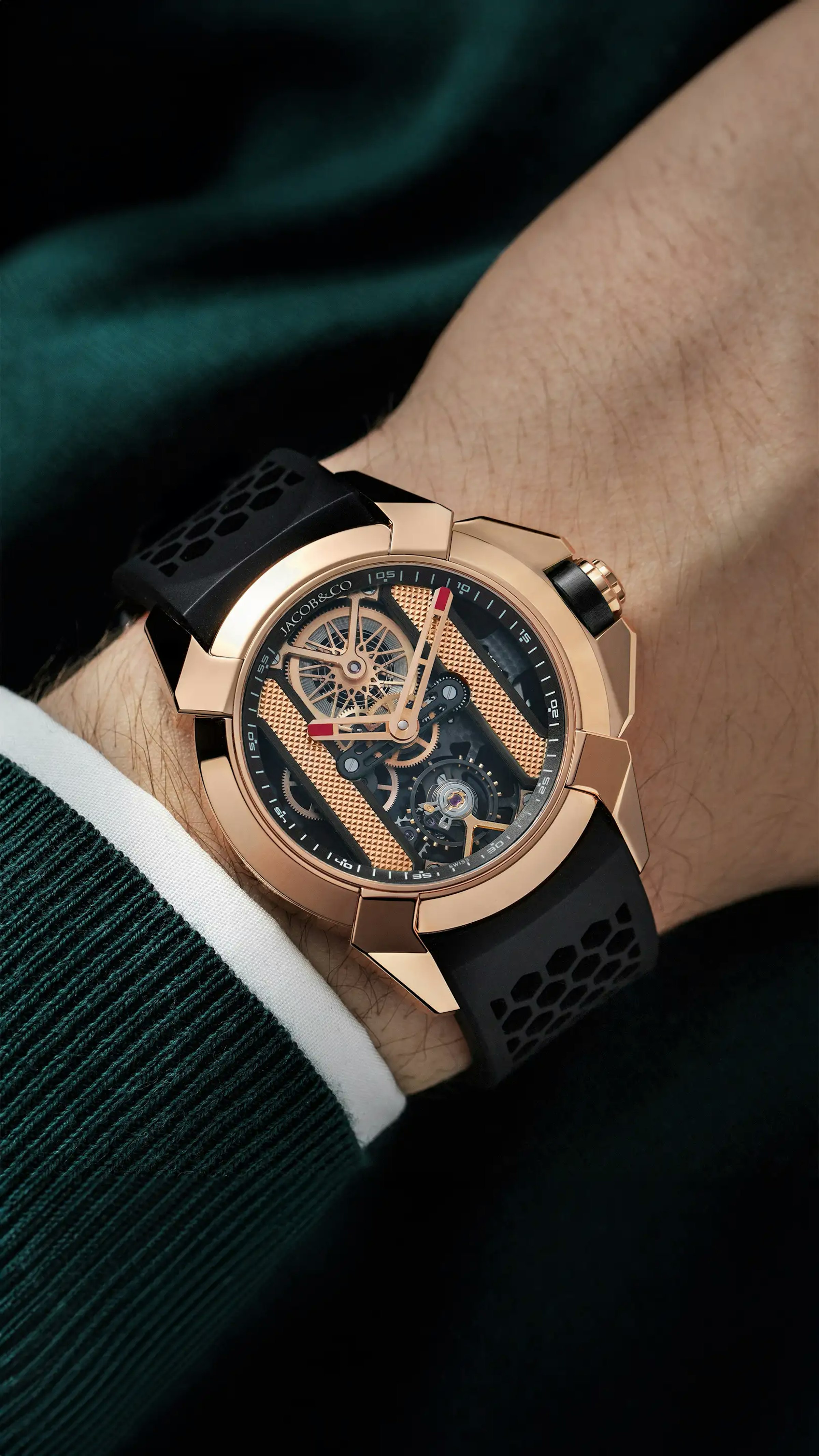 The rose gold Epic X Bridges watch, with black accents, worn on the left wrist.