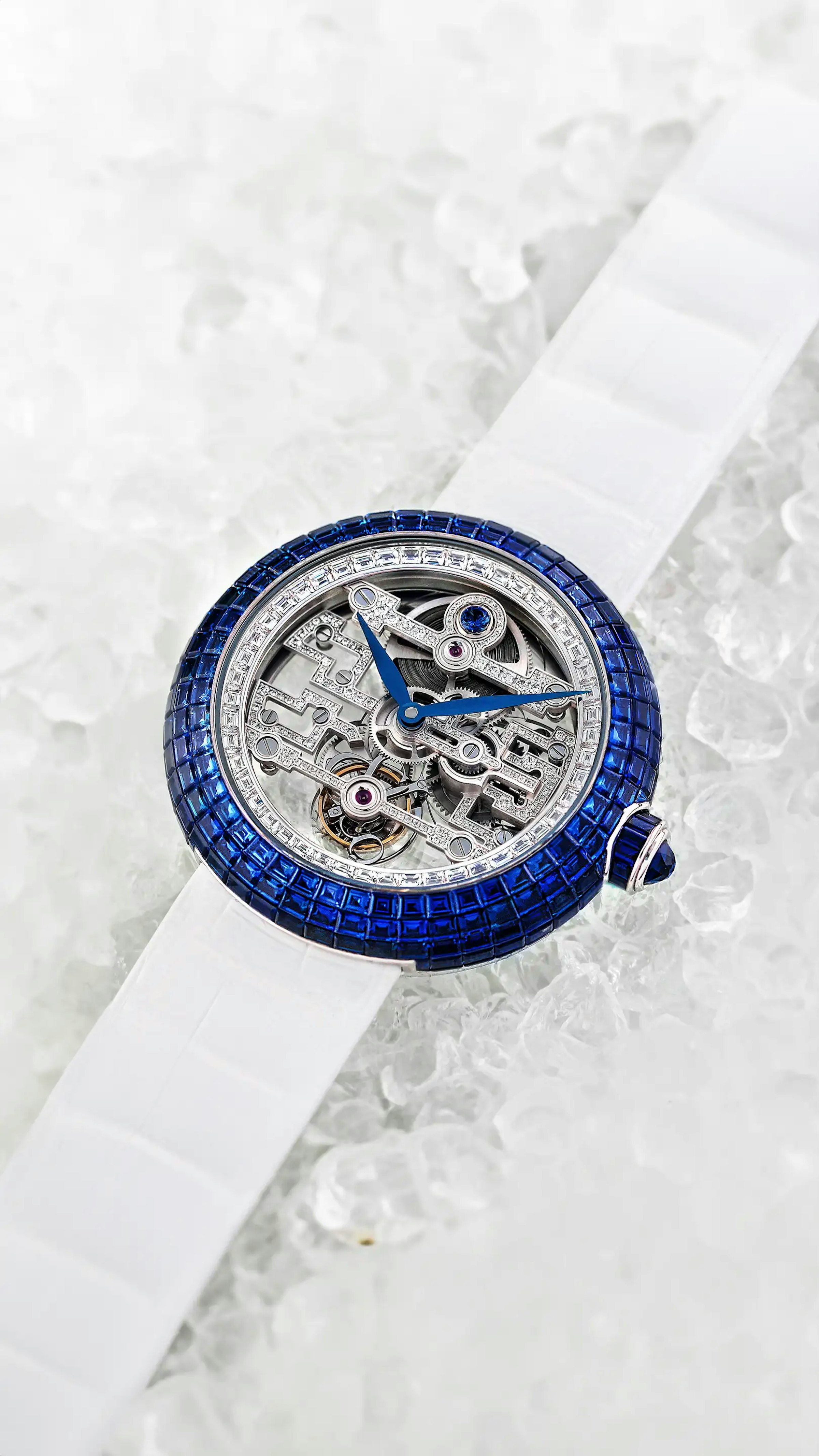 The Blue Sapphire Brilliant Art Deco Tourbillon in white gold laid flat on tube ice.