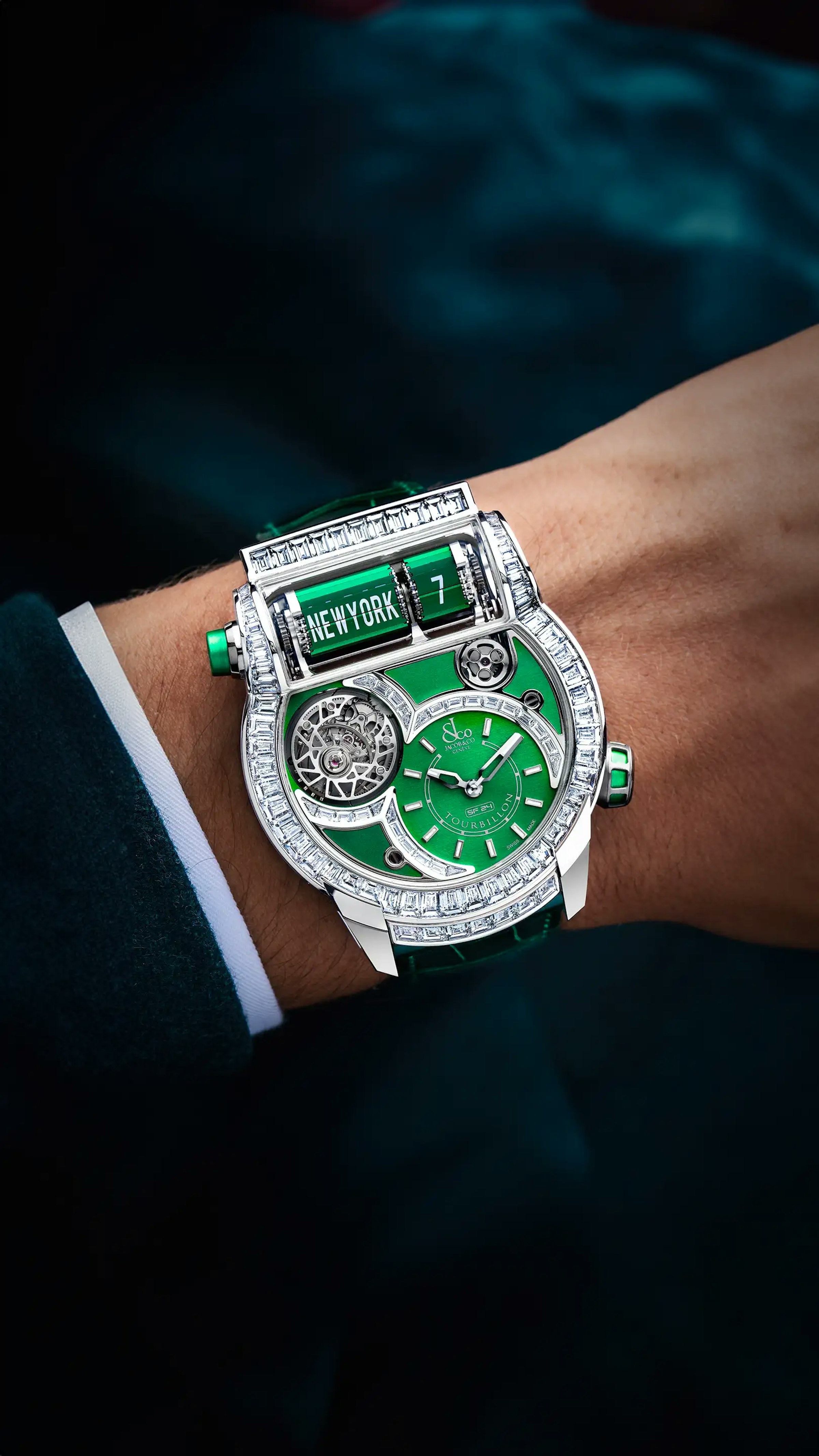 The white gold Epic SF24 Tourbillon Baguette, with green accents, worn on the left wrist.