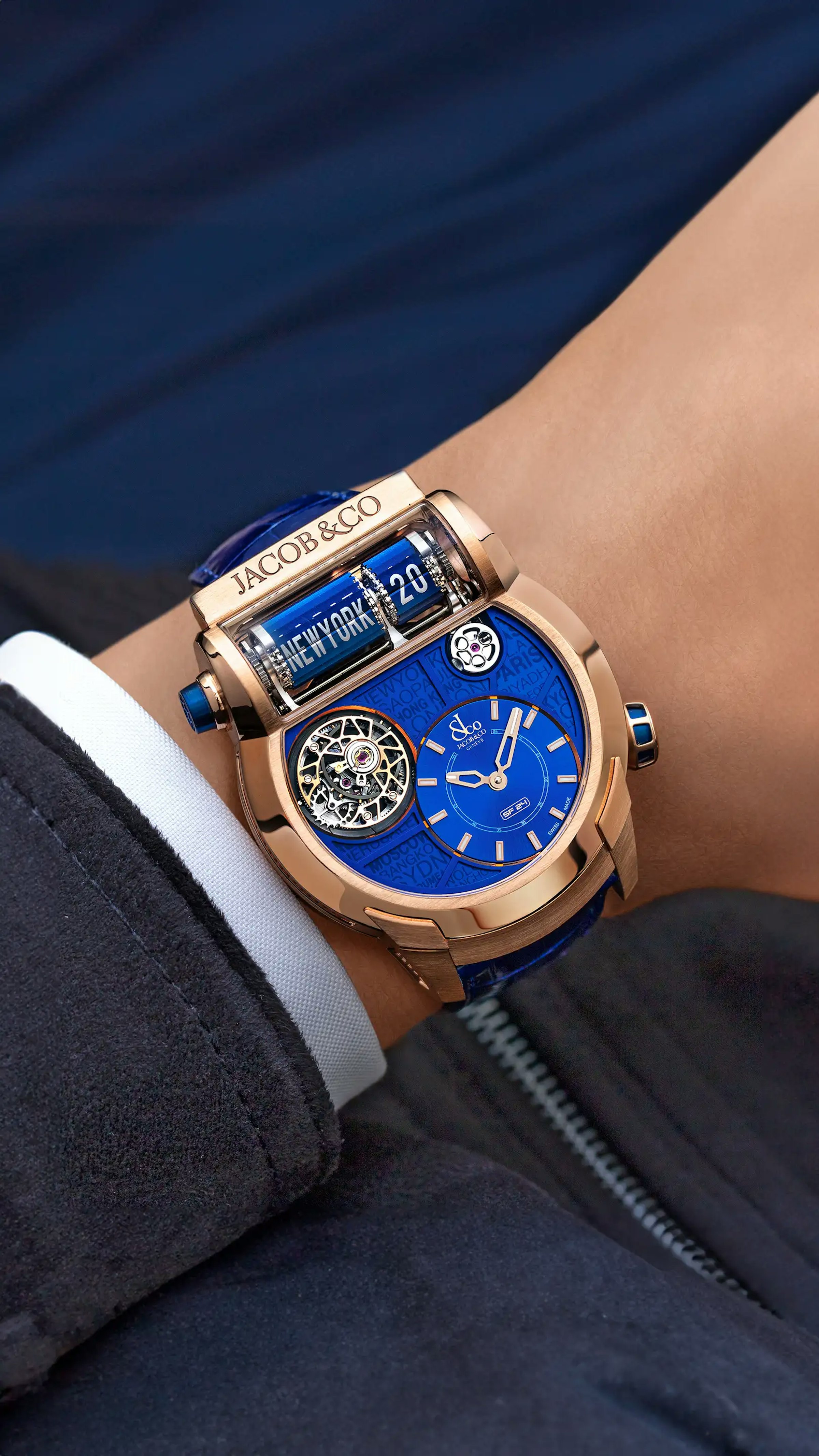 The rose gold Epic SF24 Tourbillon, with blue accents and a blue city dial, worn on the left wrist.