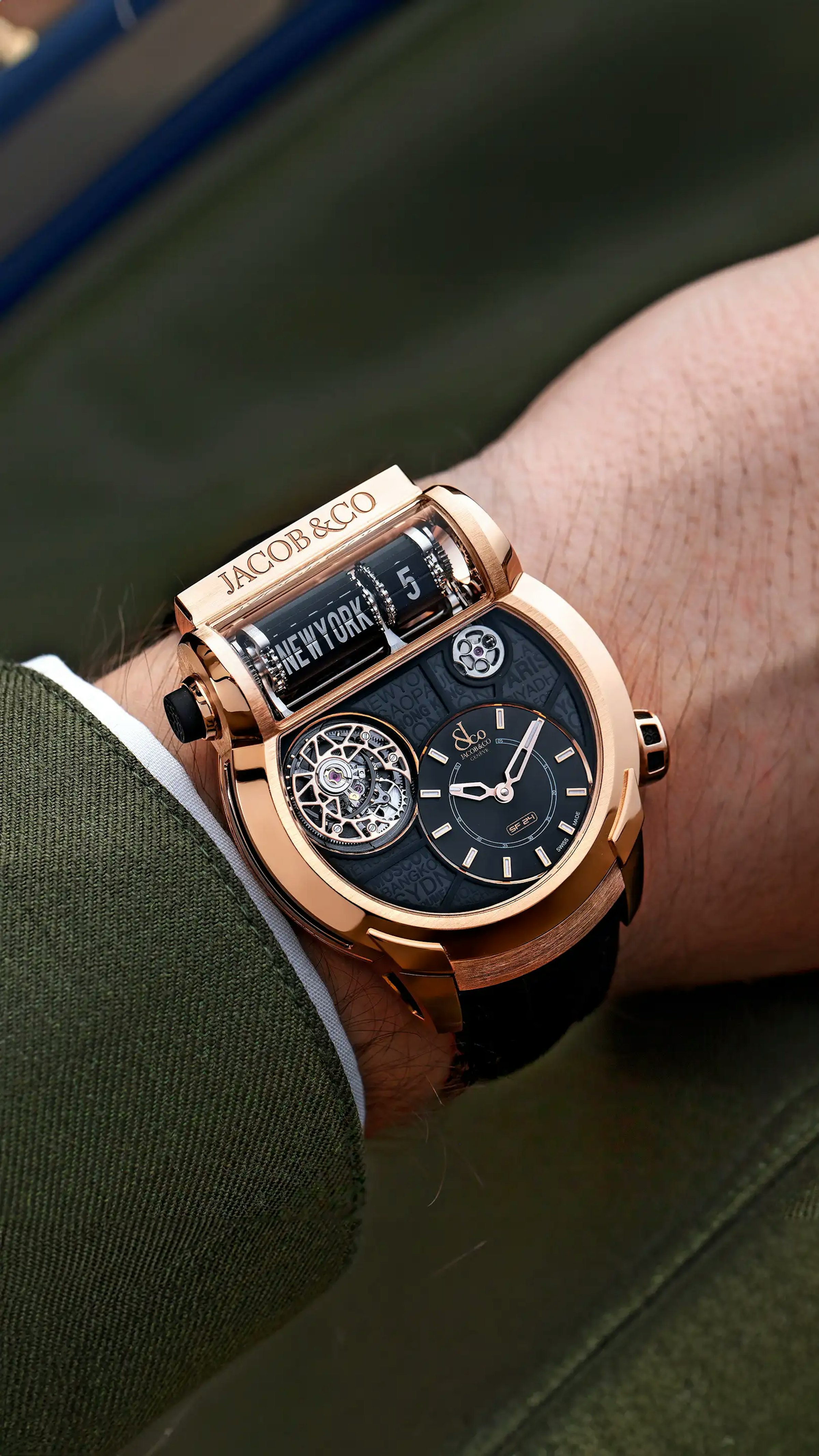The rose gold Epic SF24 Tourbillon, with black accents and a black city dial, worn on the left wrist.