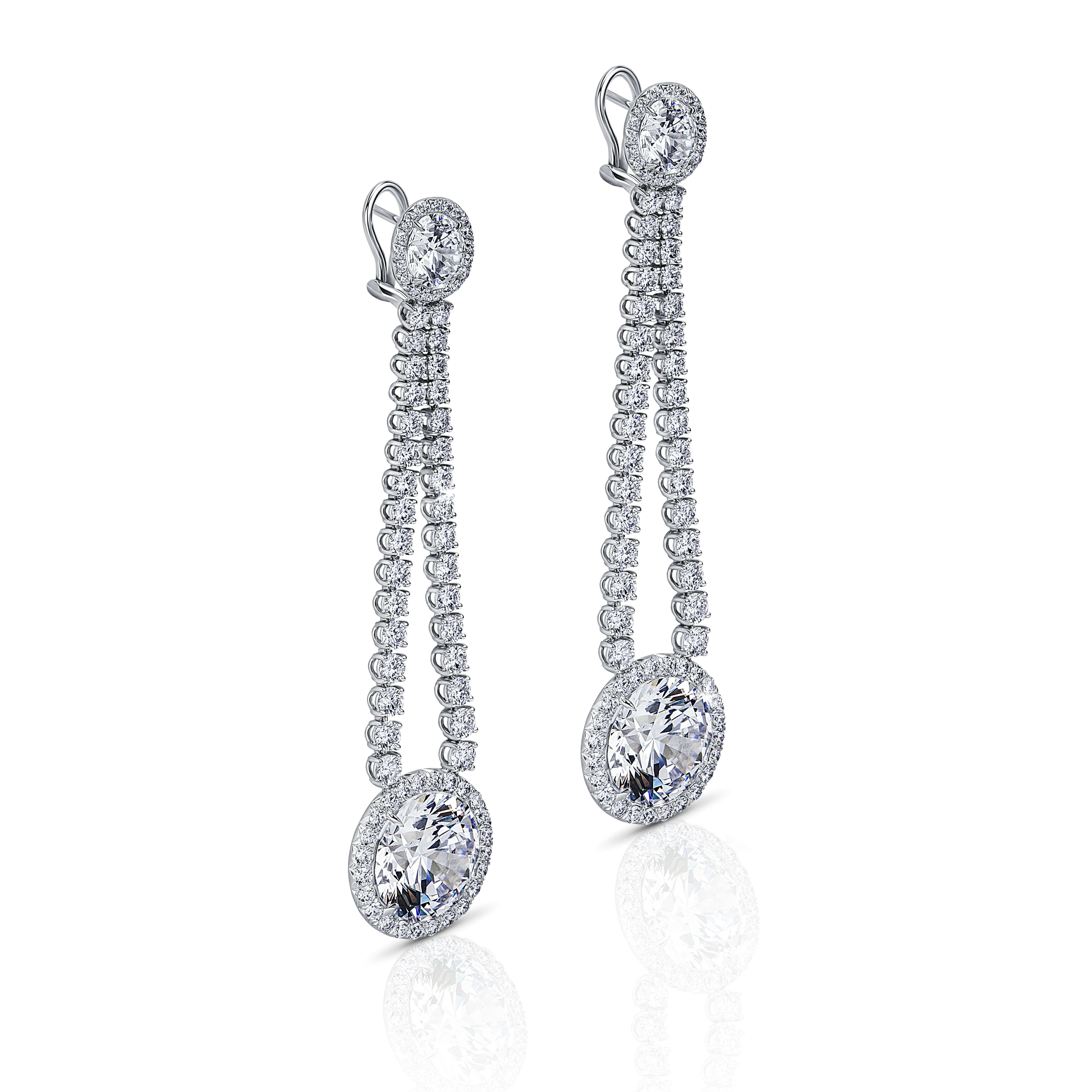 the earrings, suspended upright, tilted to the right.