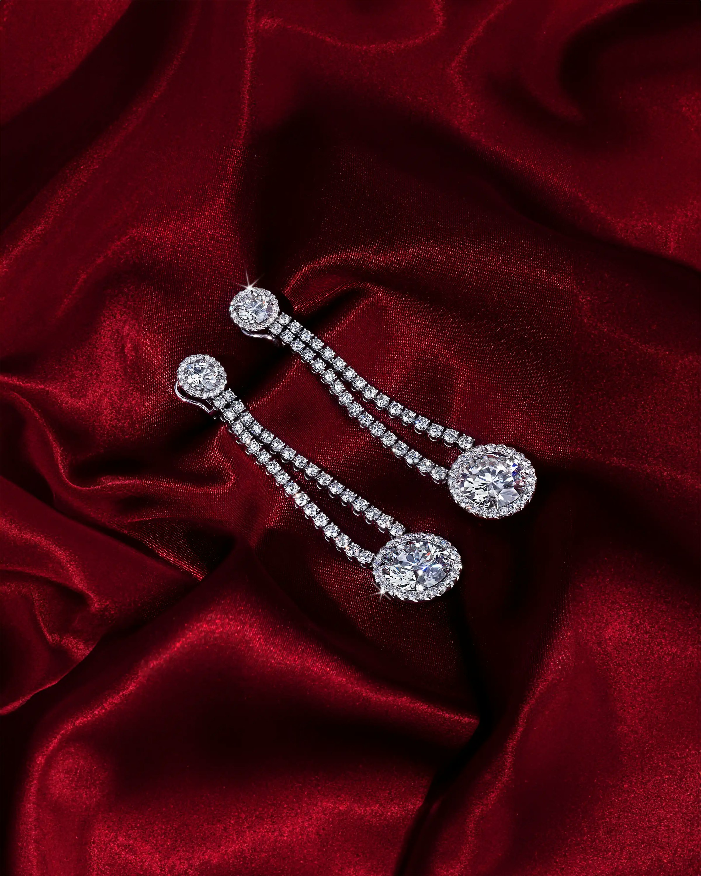 the earrings, laid flat on a silk cloth