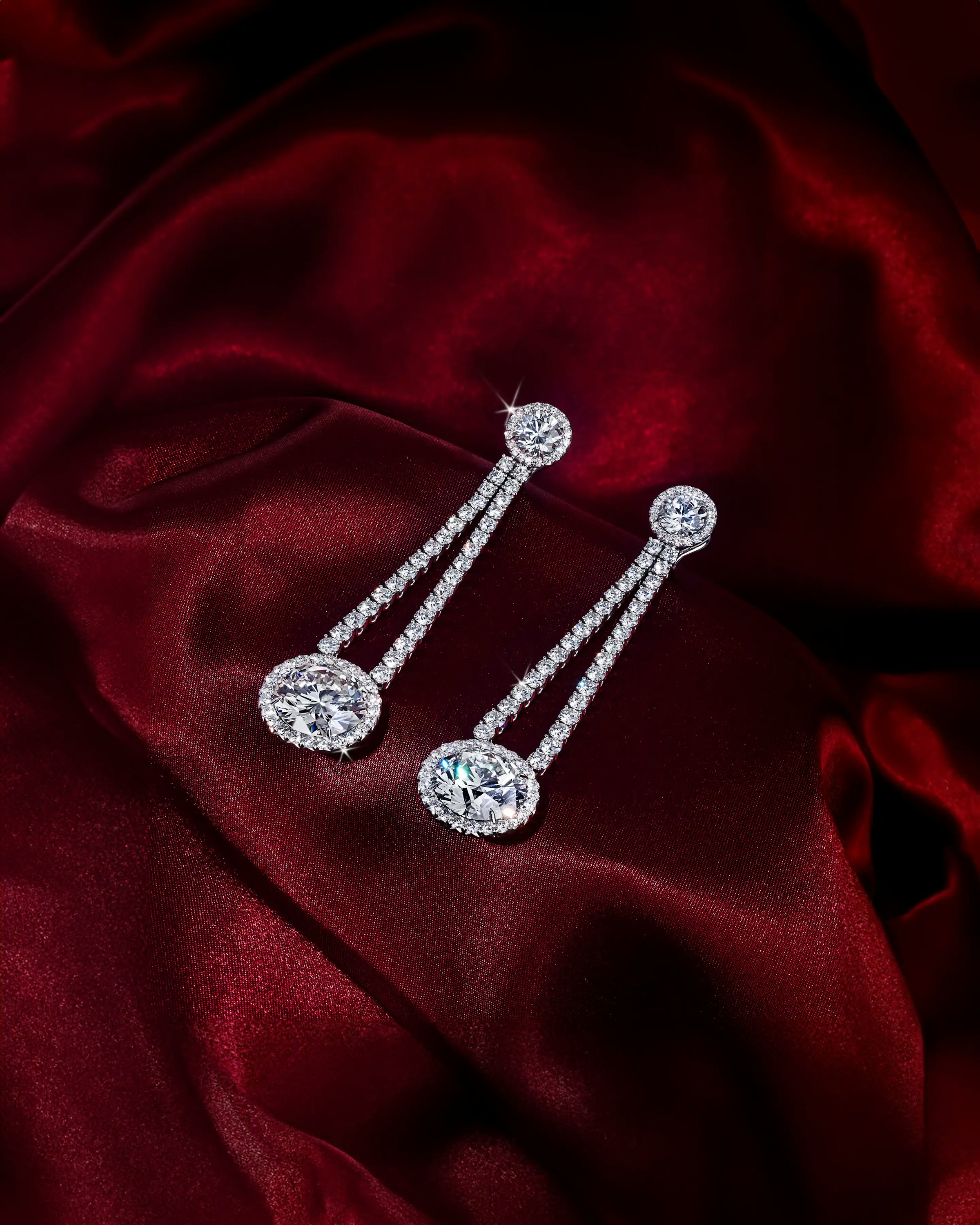 the earrings, laid flat on a silk cloth