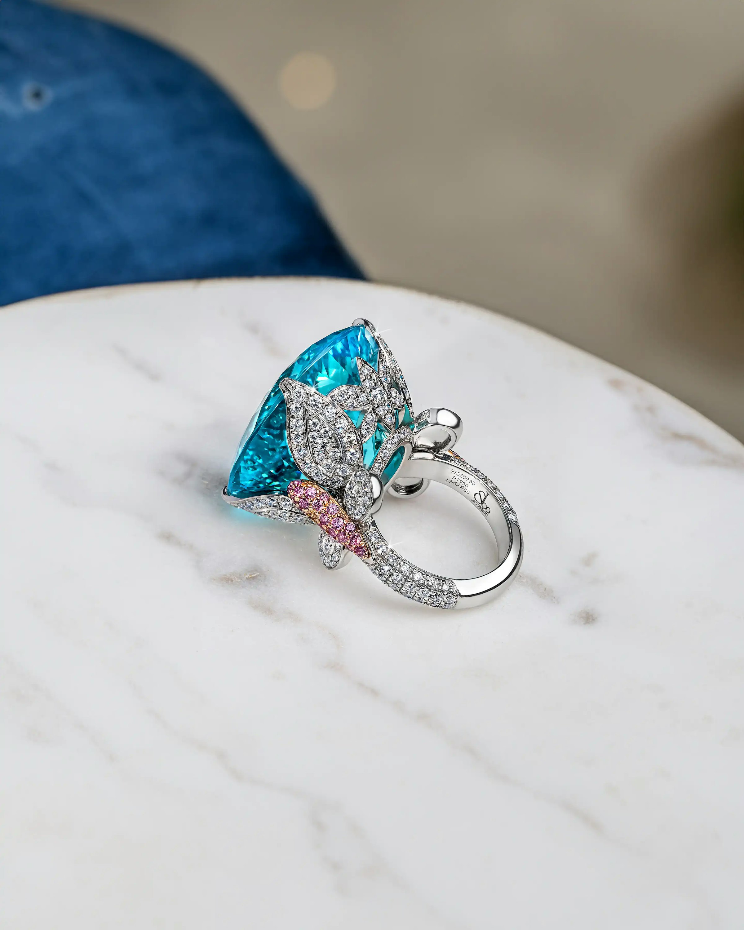 the ring laid flat on a marble surface, focusing on the diamond setting of the band