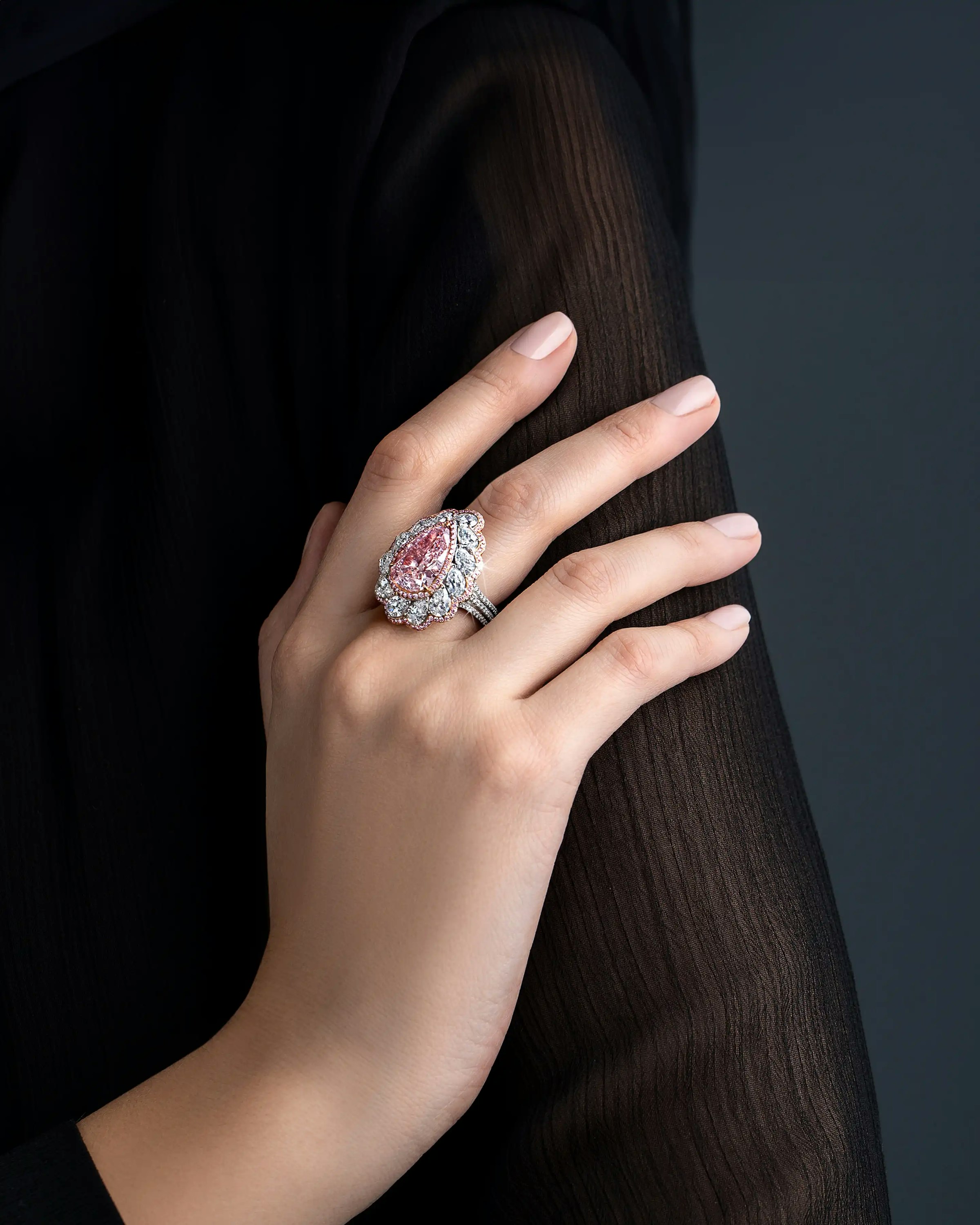 a model wearing the ring on their right middle finger