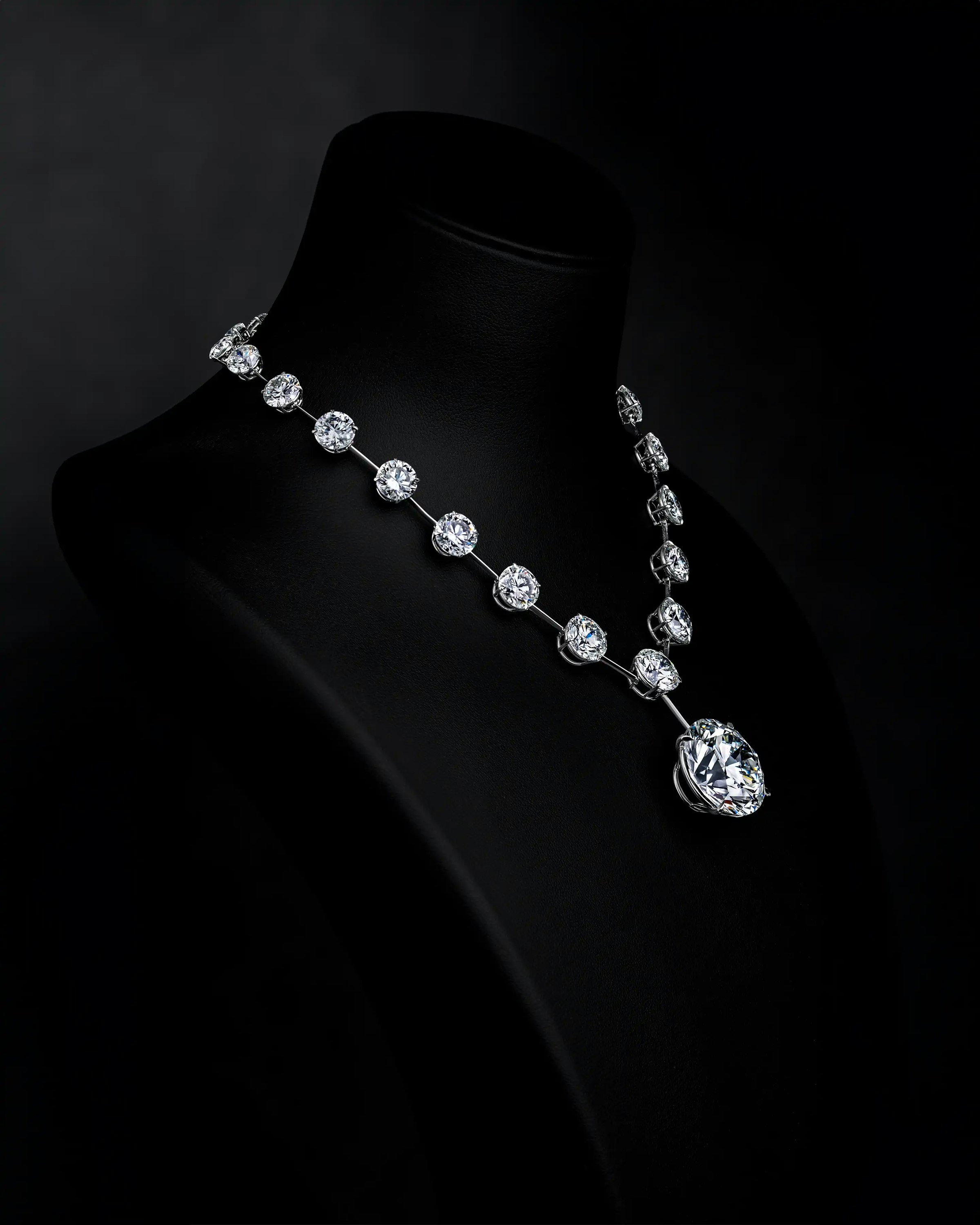 the necklace, worn on a mannequin display, tilted to the righthand side