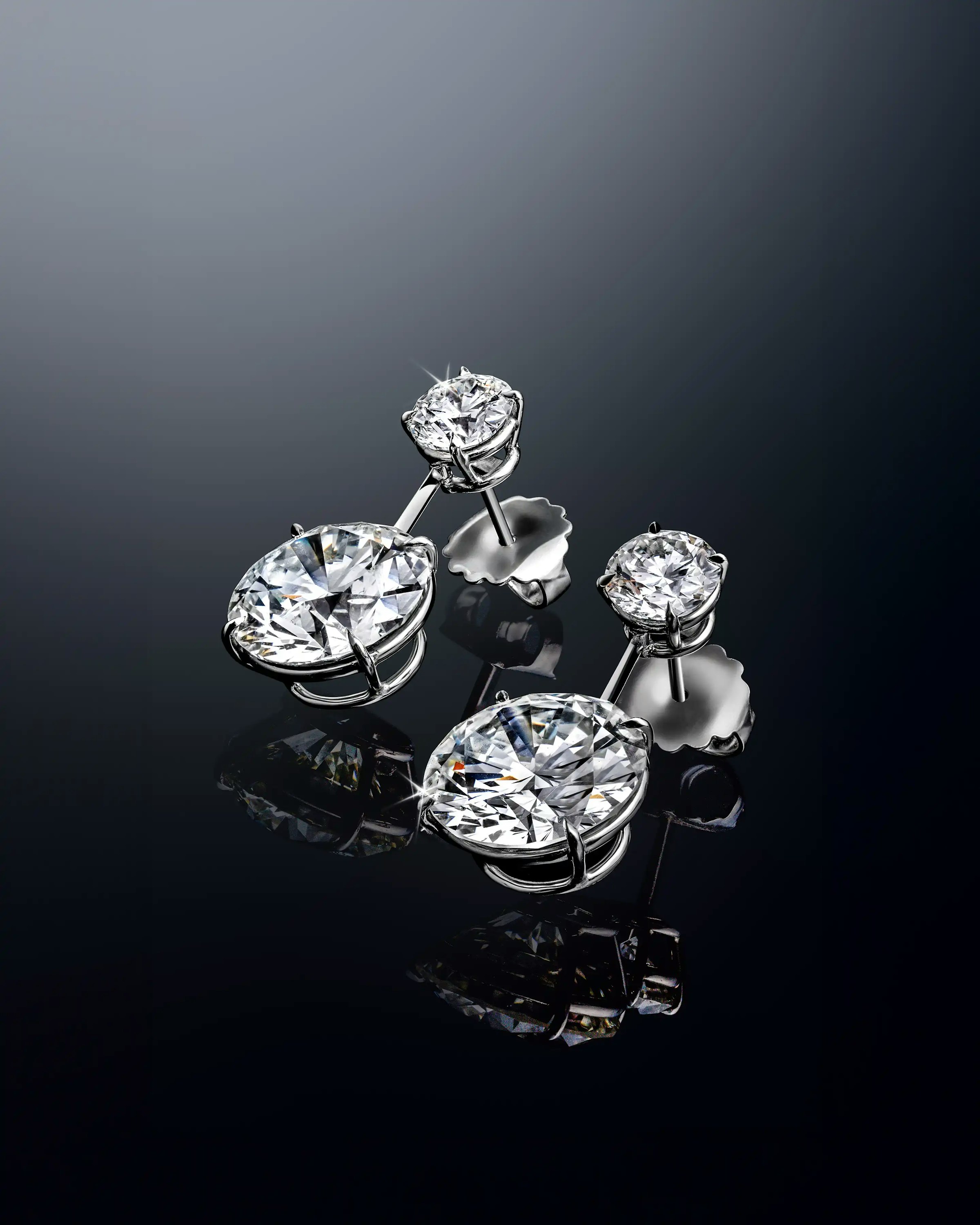 the earrings, laid flat, tilted to the lefthand side.