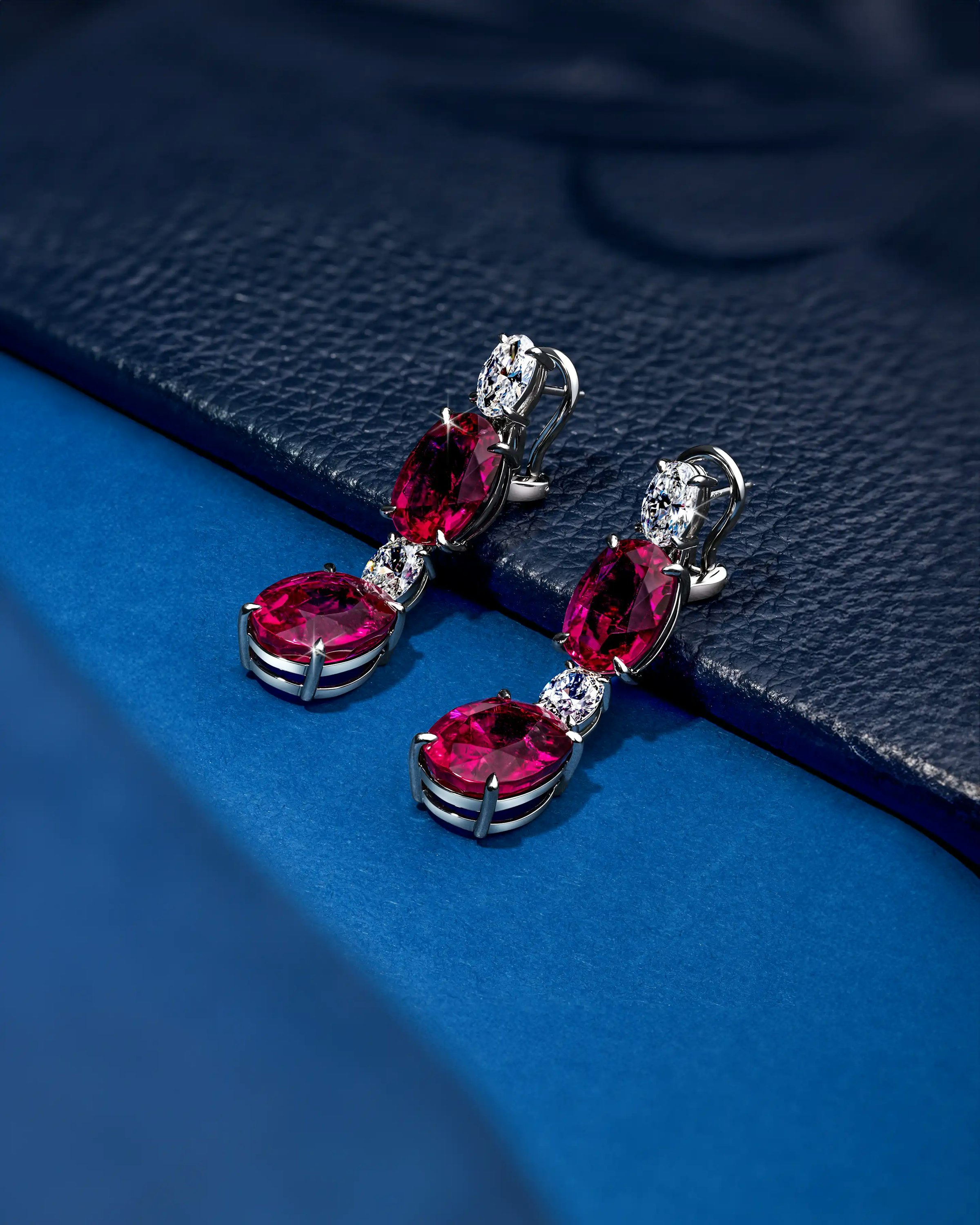 the earrings, laid on an uneven surface, tilted to the lefthand side