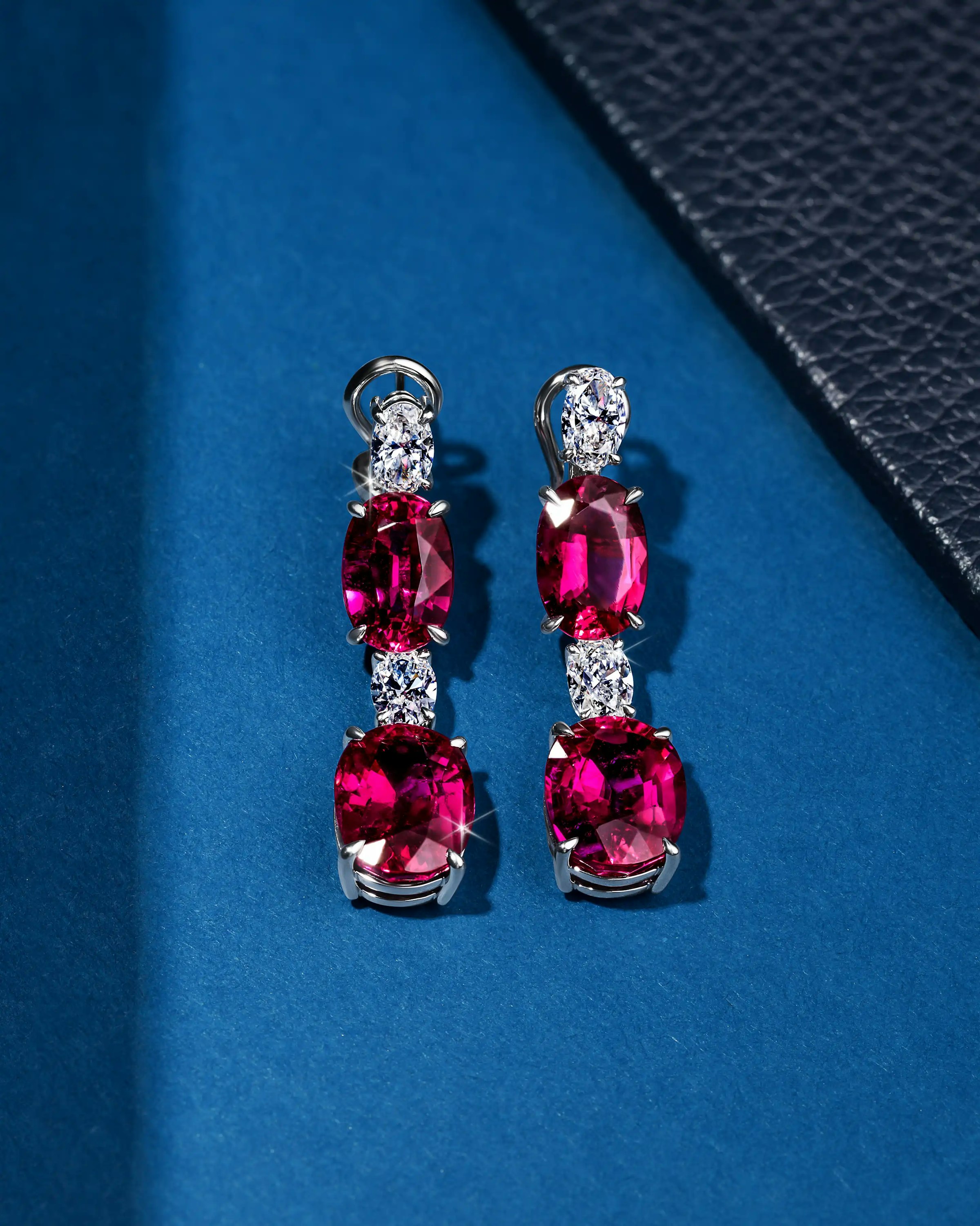 the earrings, laid on a surface