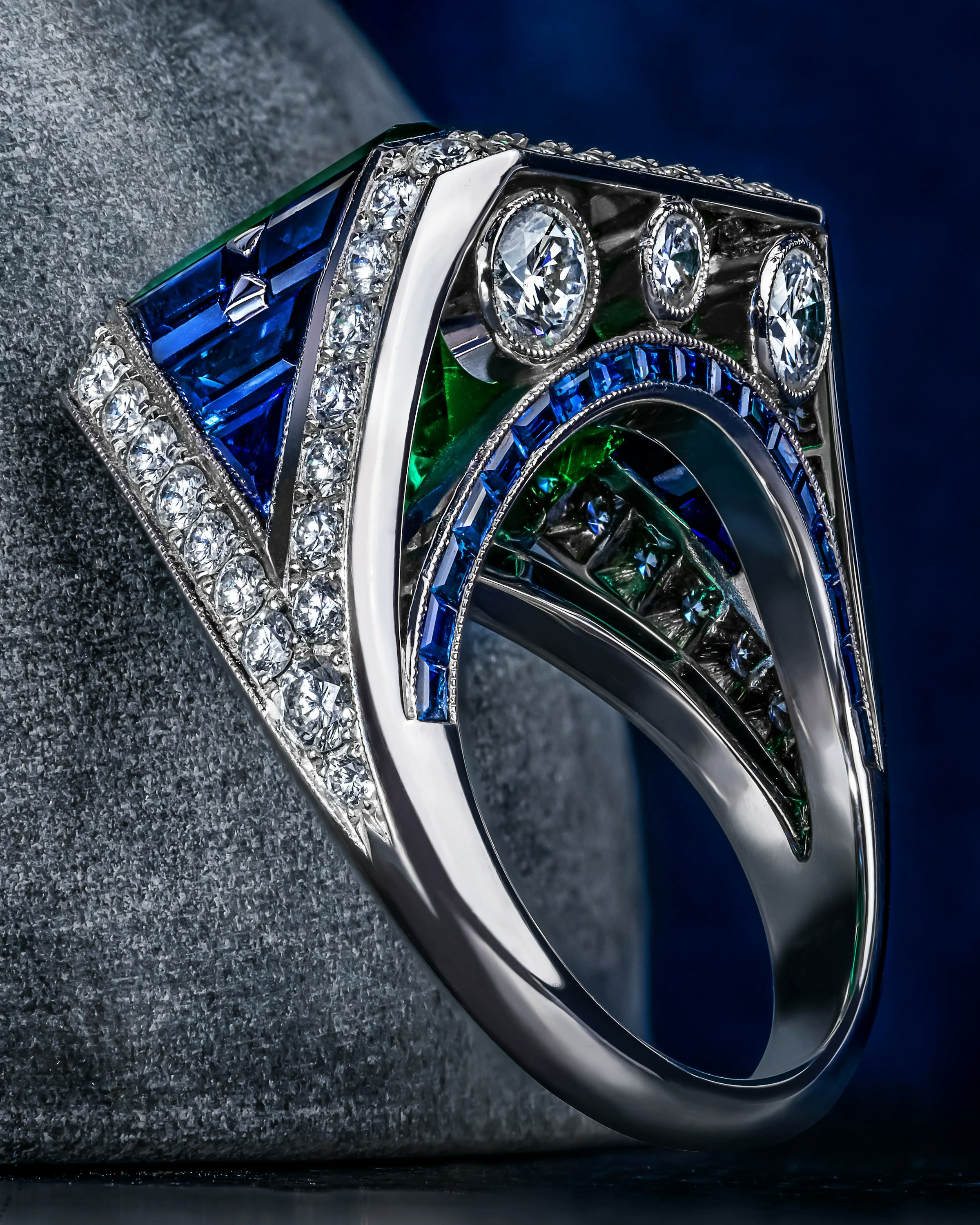 close up of the eye of the emerald ring, standing atop a surface.