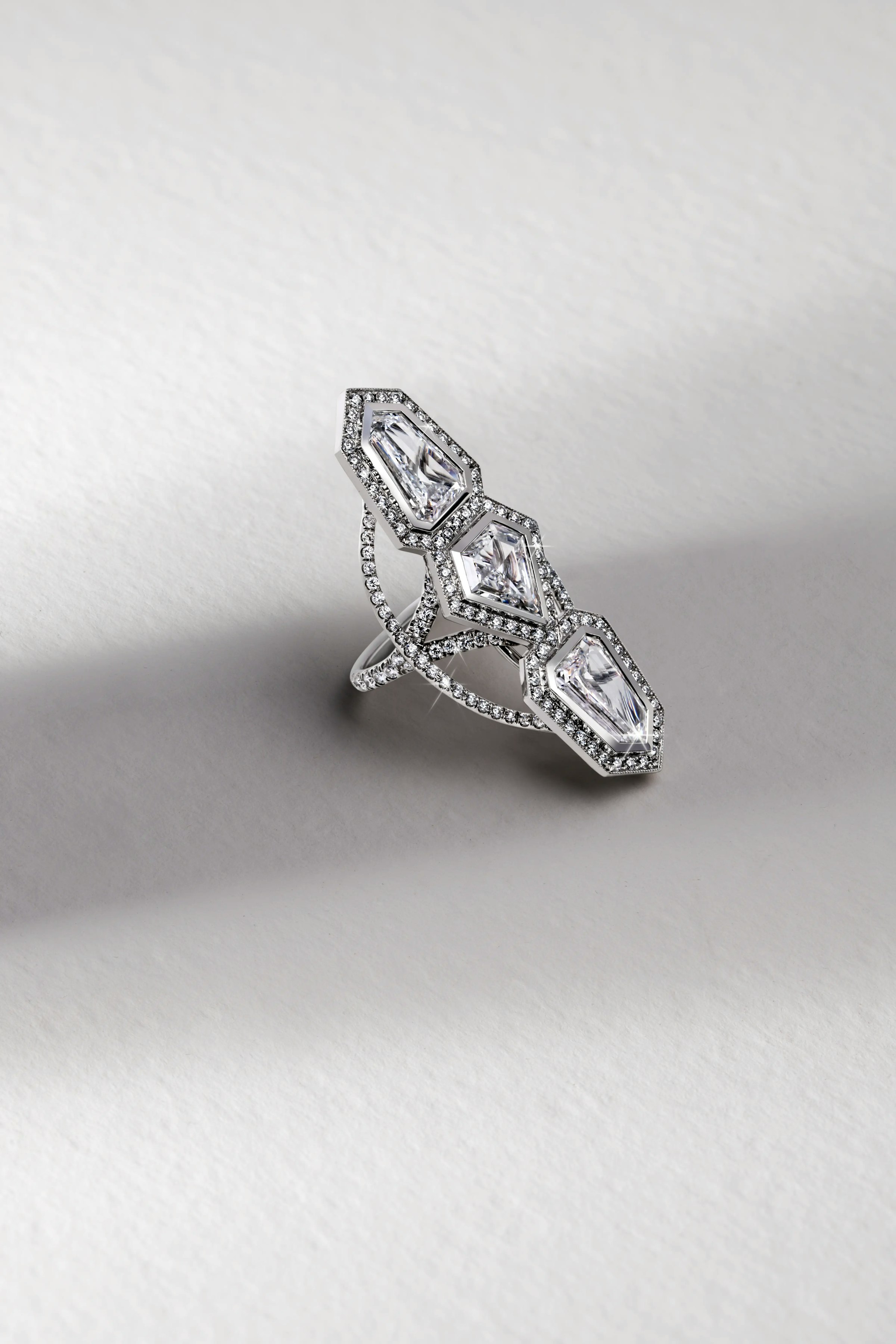 the annika white diamond ring, laid flat on a surface.