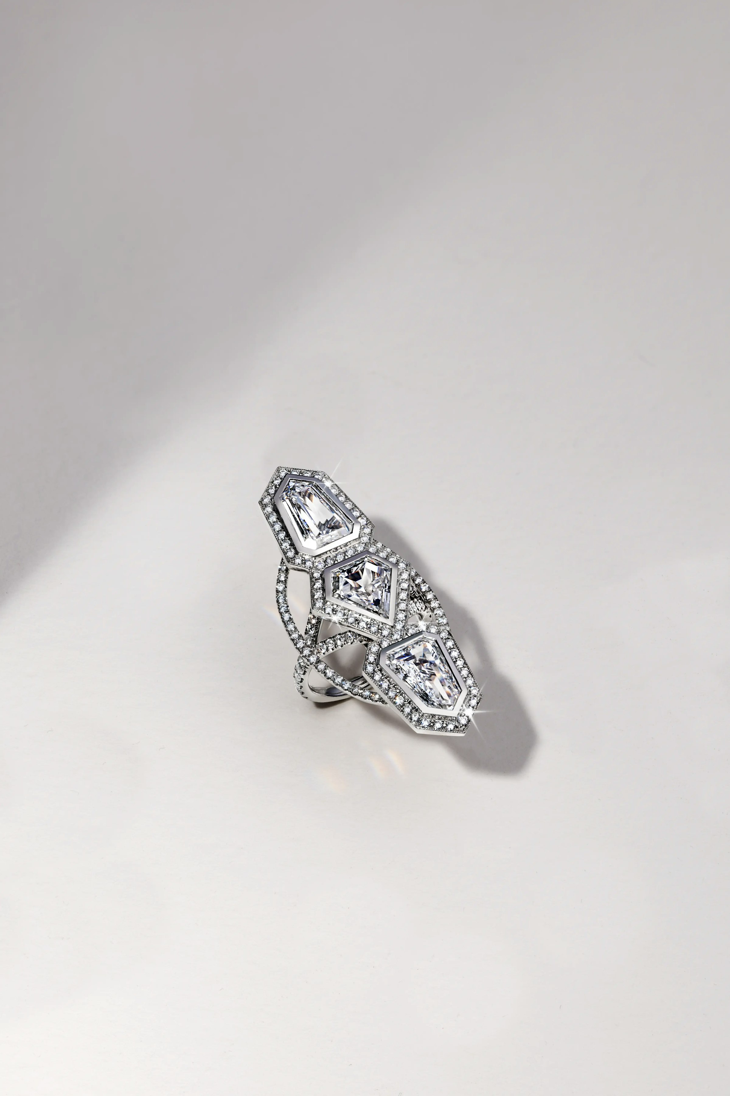 the annika white diamond ring, laid flat on a surface.