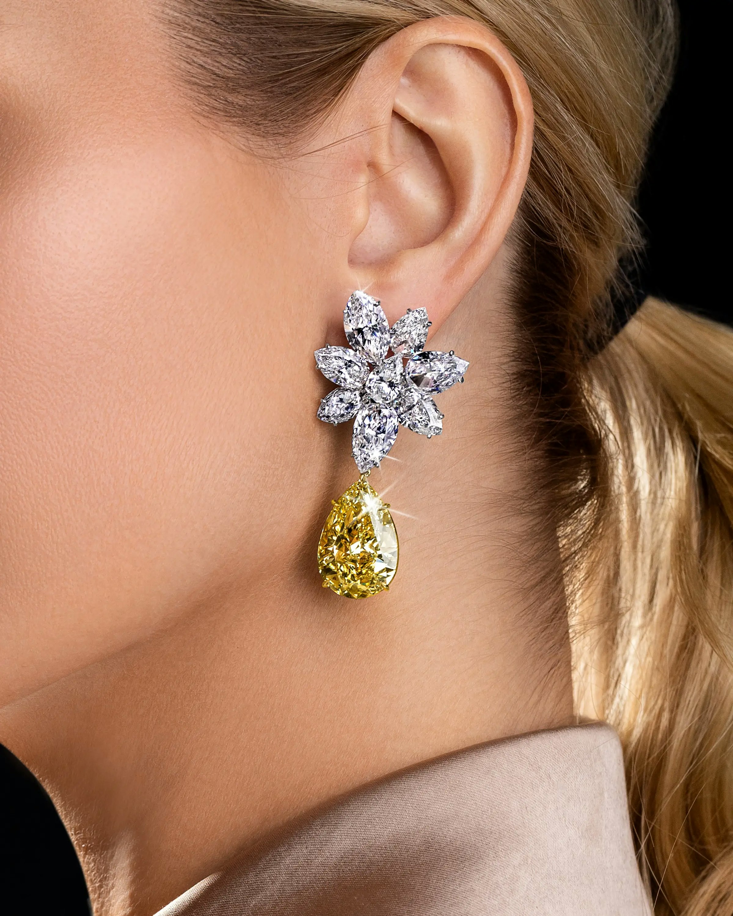 a model wears the yellow garden earrings.