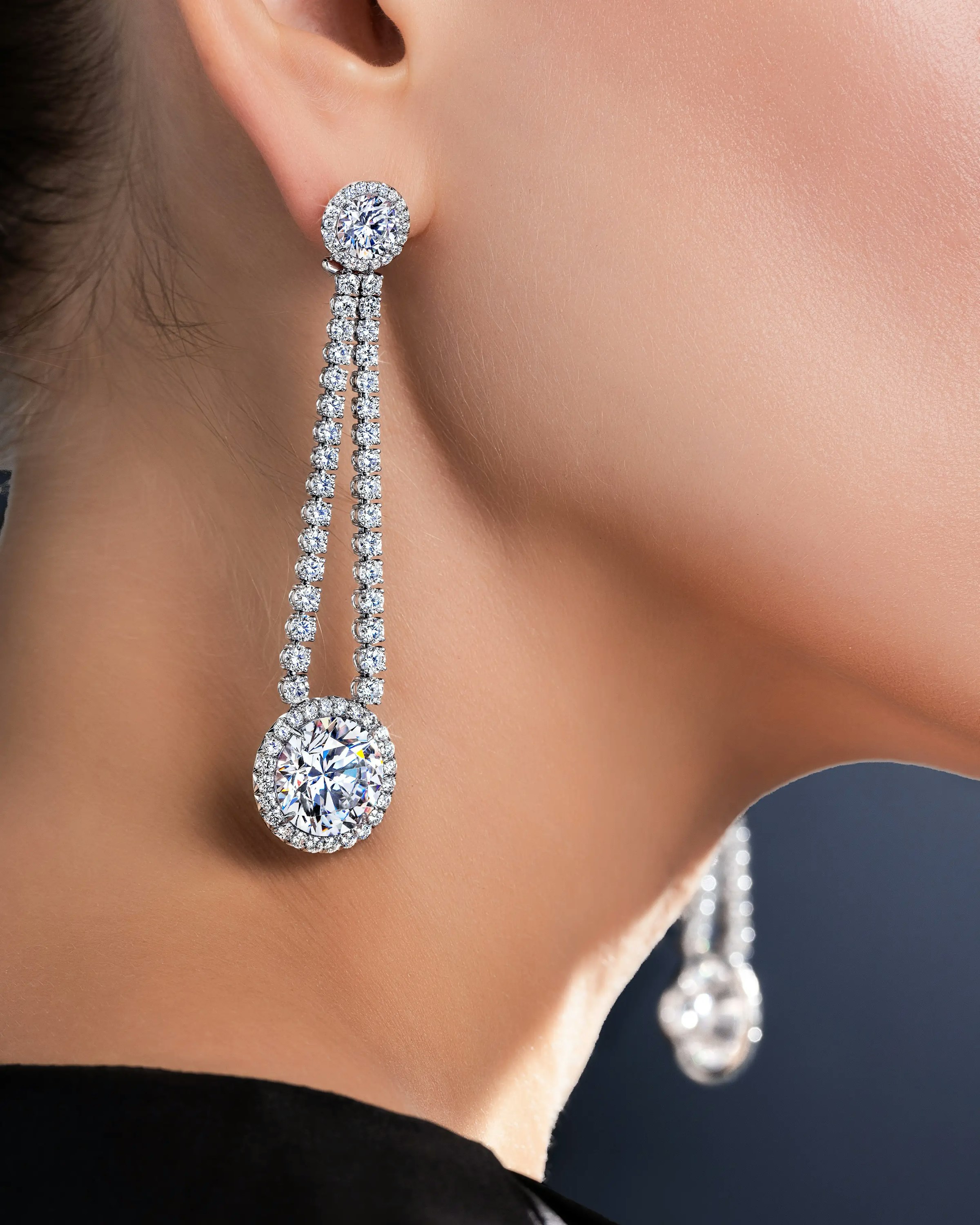 a model wears the dew drop earrings.