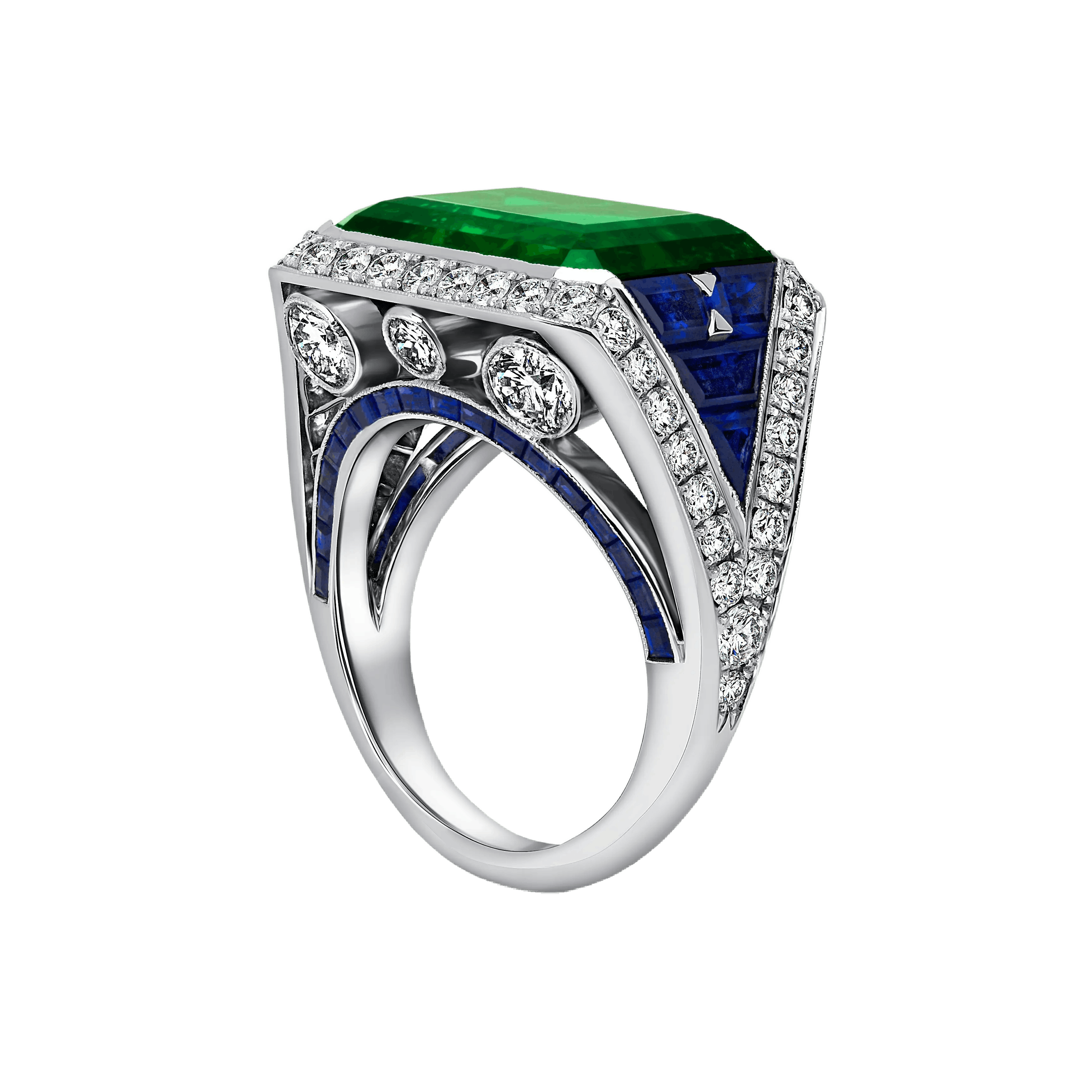the eye of the emerald ring, positioned upright, facing the viewer 3/4 of the way to show the diamond and sapphire setting.
