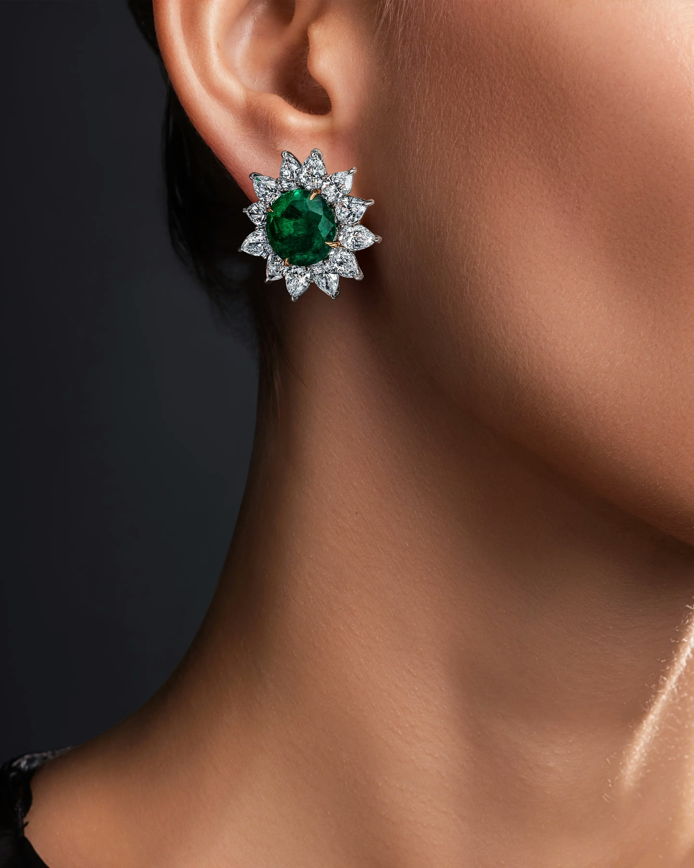 a model wears the emerald flower earrings.
