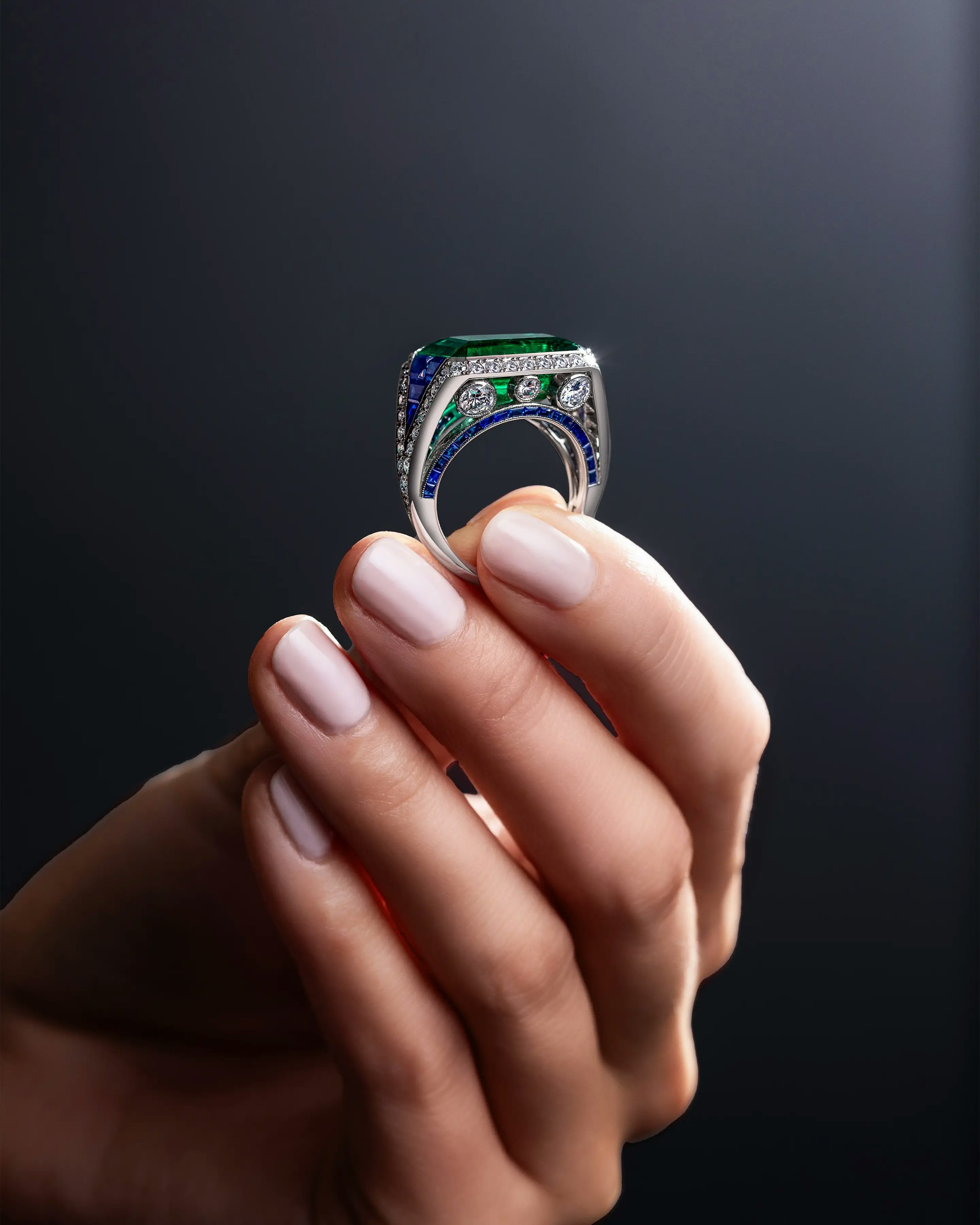 a model holds the eye of the emerald ring.