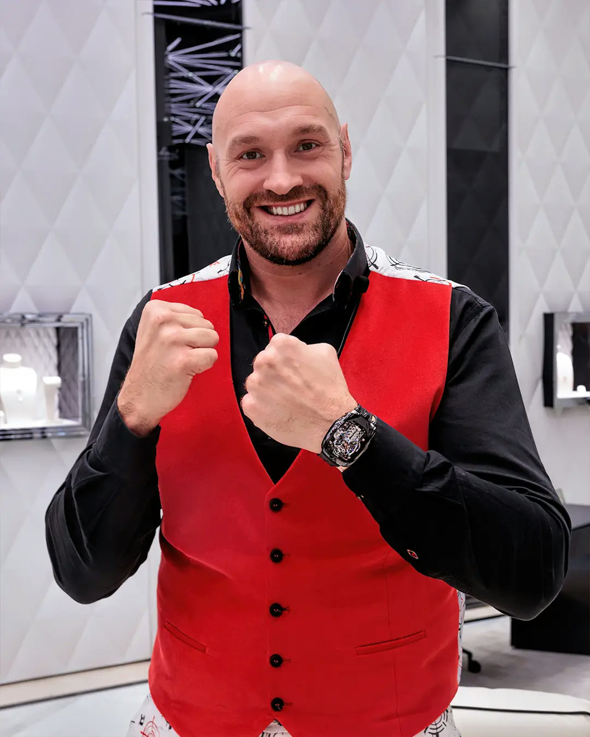 Image of a men with his clenched fists up and a watch on his left wrist