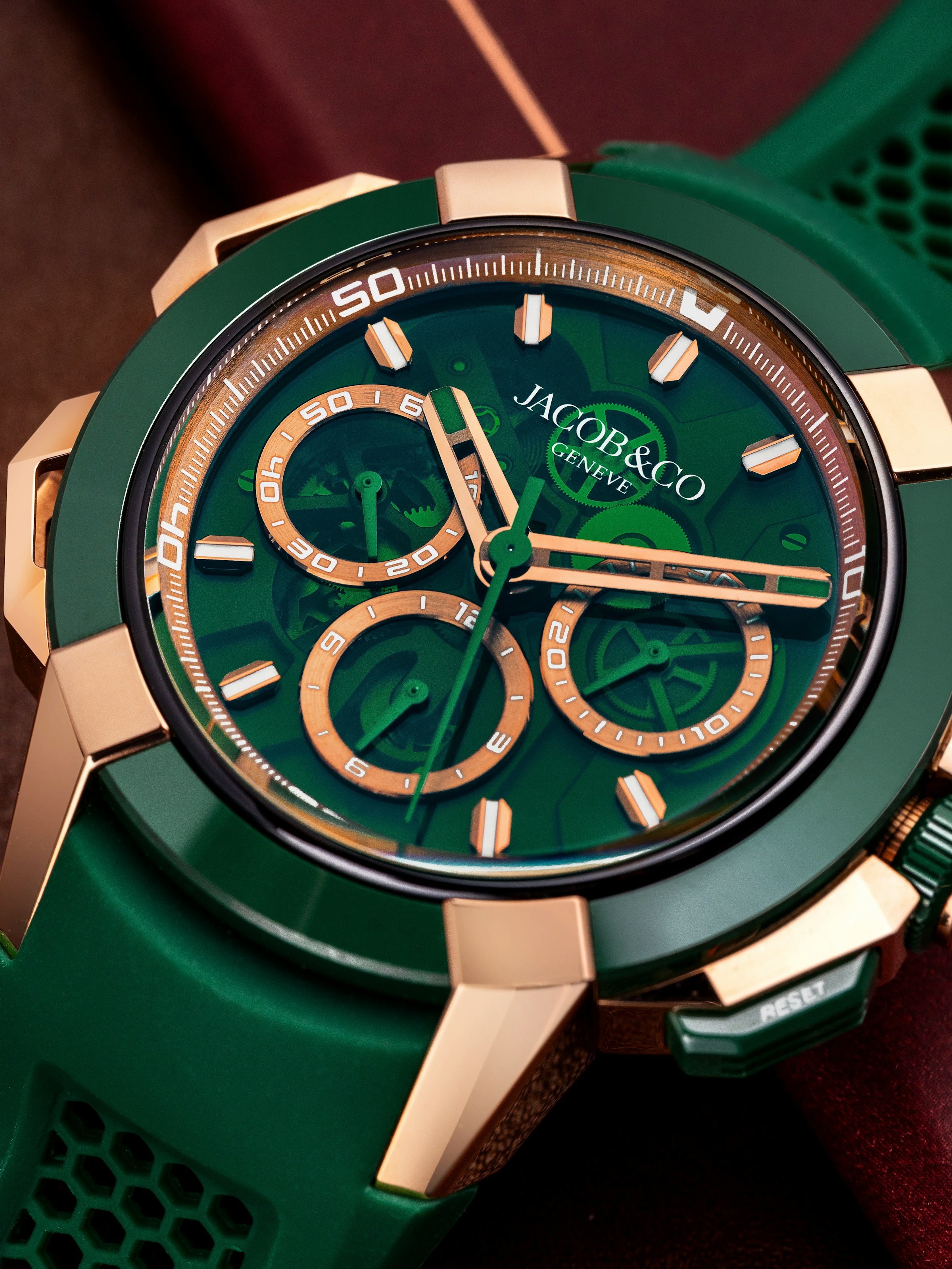 A close-up image of watch face of Epic X Chrono 44mm in green and rose gold