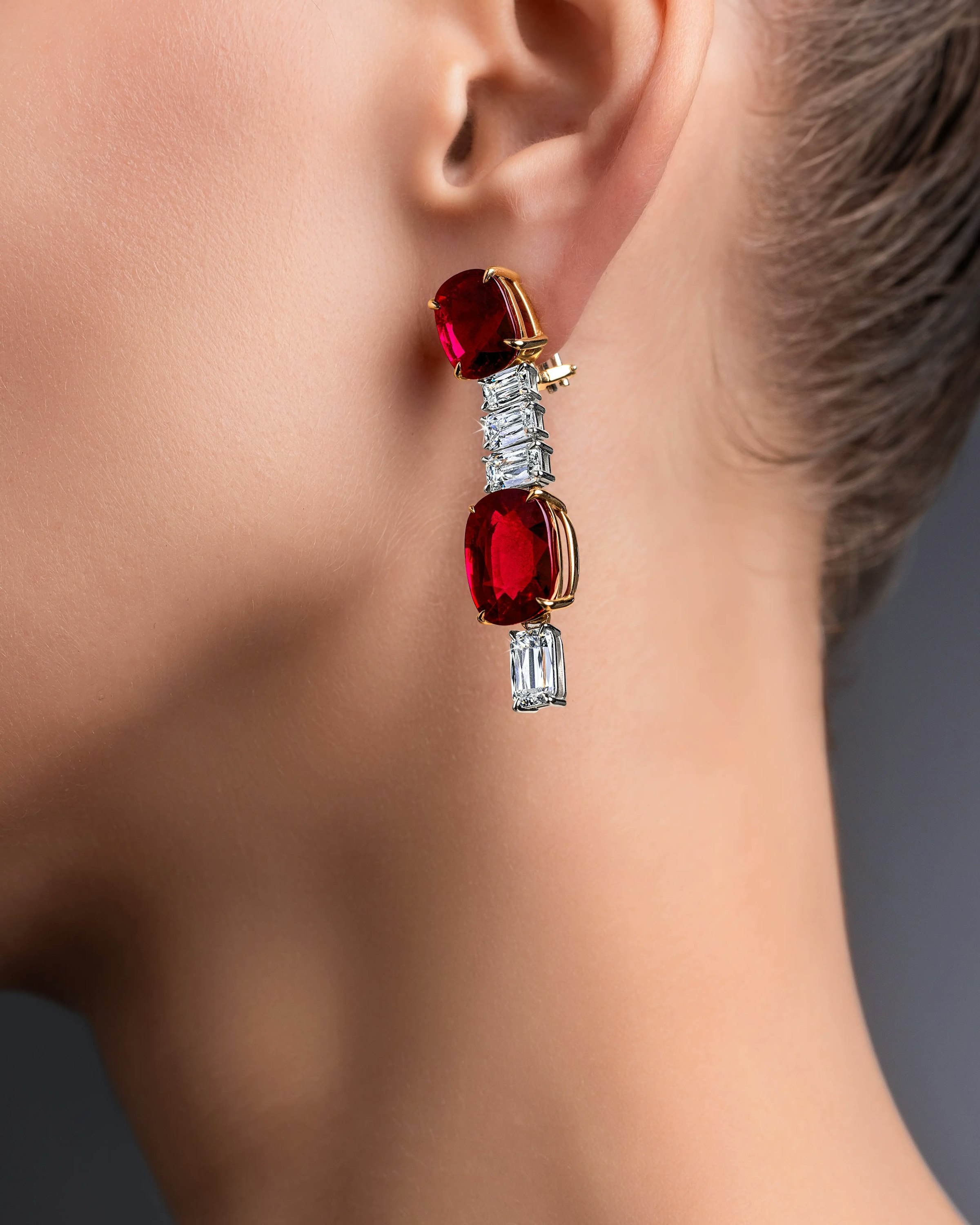 close up of a model wearing the crimson cascade earrings on her left ear.