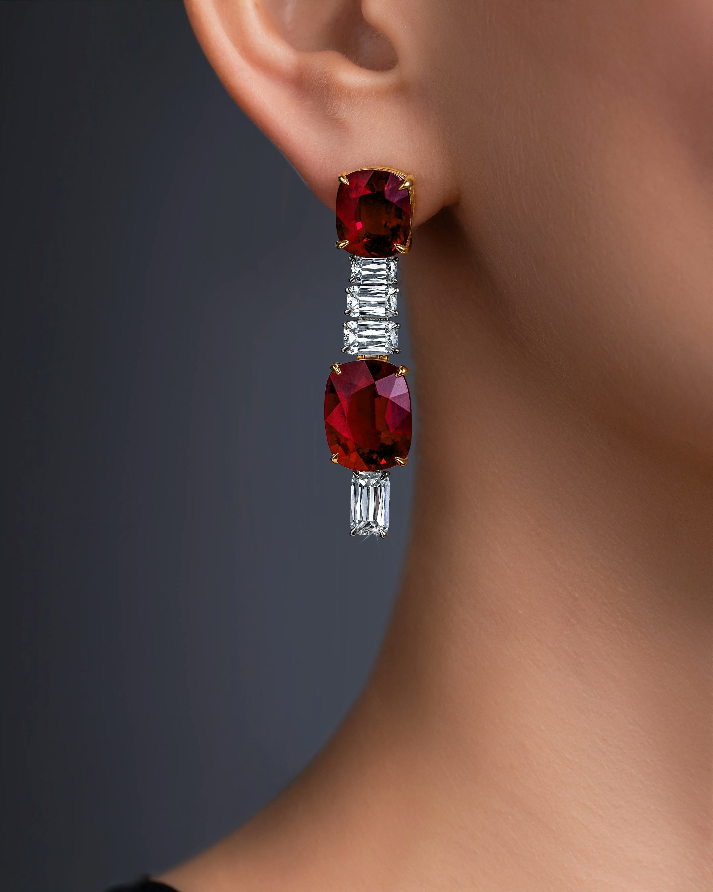 close up of a model wearing the crimson cascade earrings on her right ear.