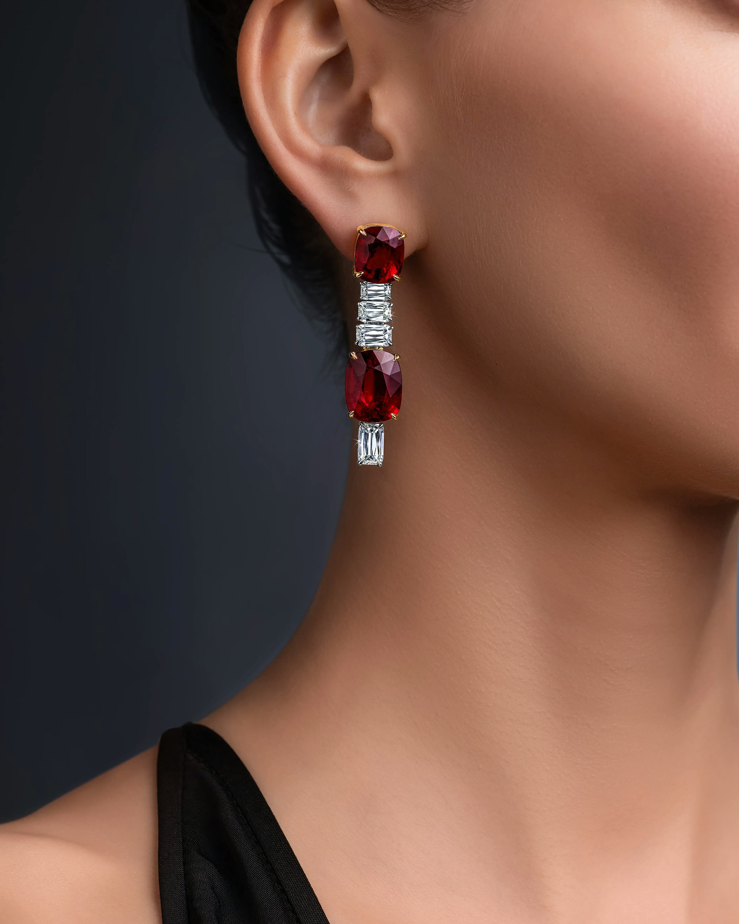 a model wears the crimson cascade earrings on her right ear.