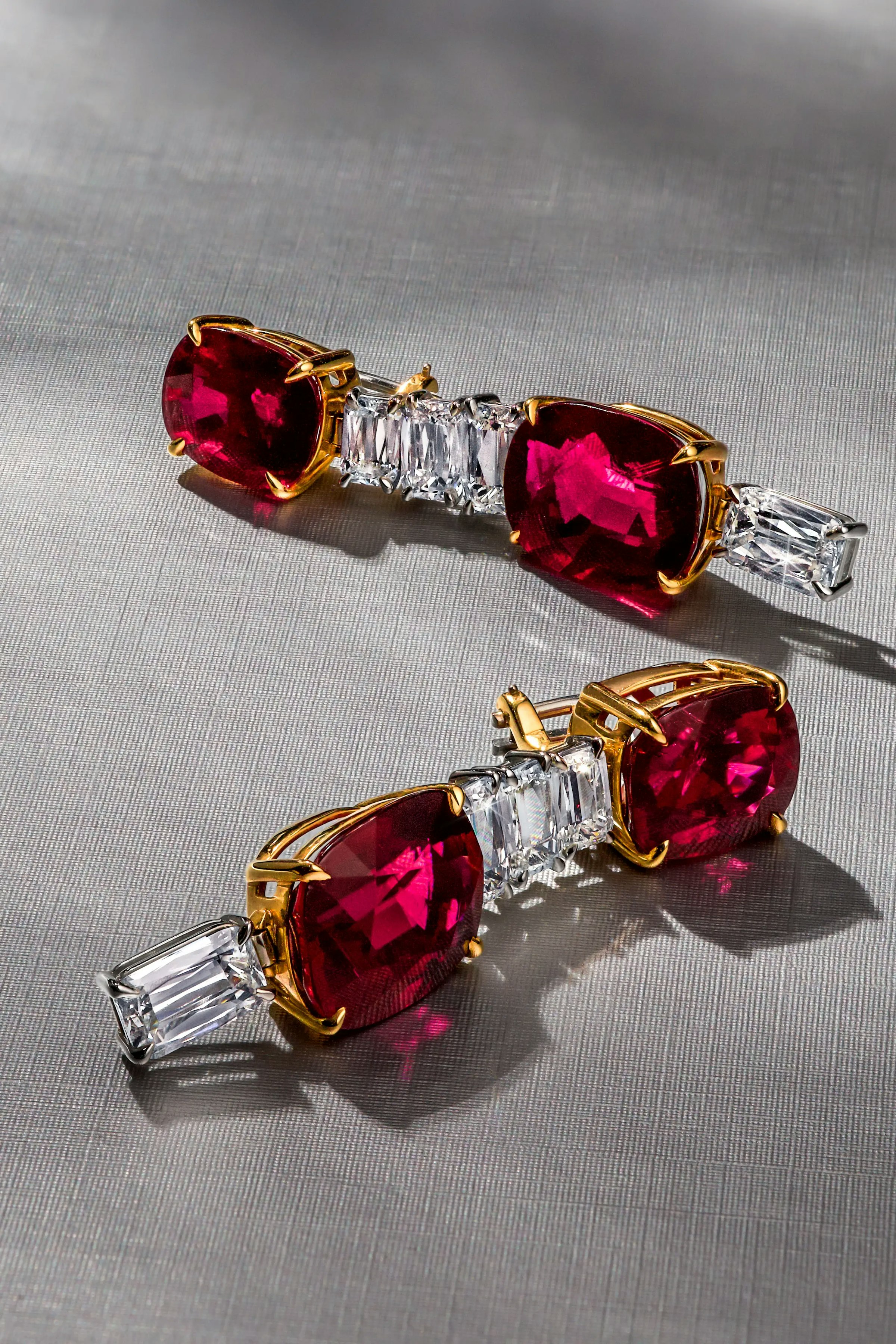 the crimson cascade earrings are laid on their sides.