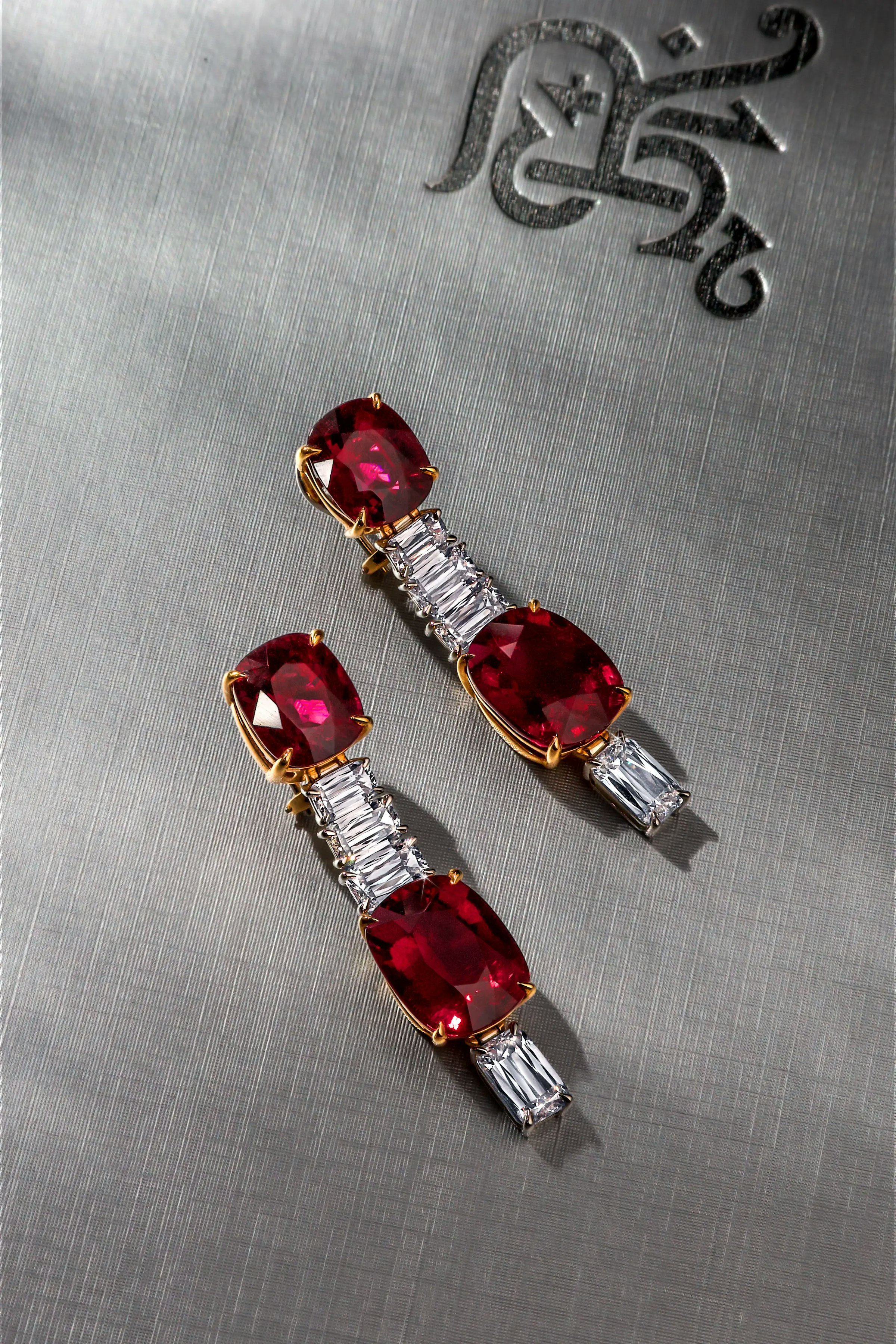 the crimson cascade earrings, laid flat on a gray surface.