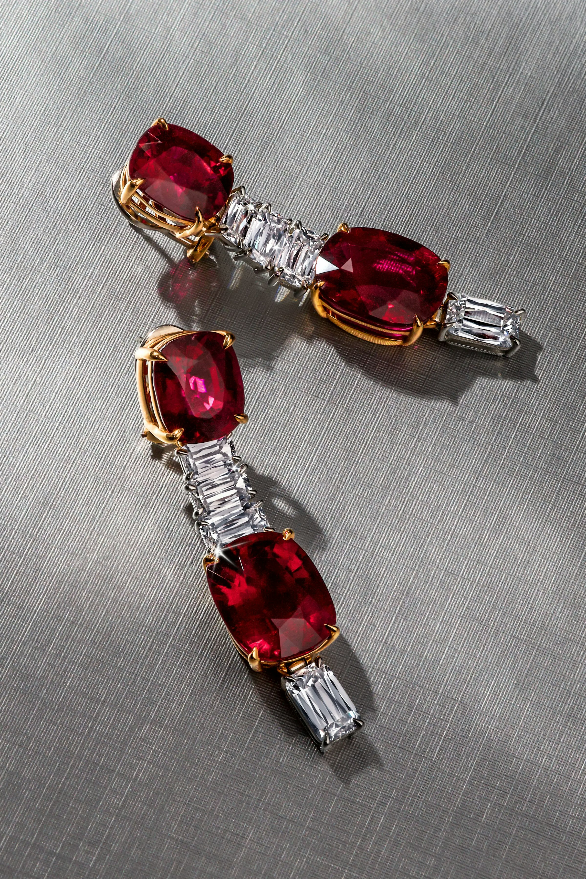 another image of the crimson cascade earrings laid flat on a gray surface