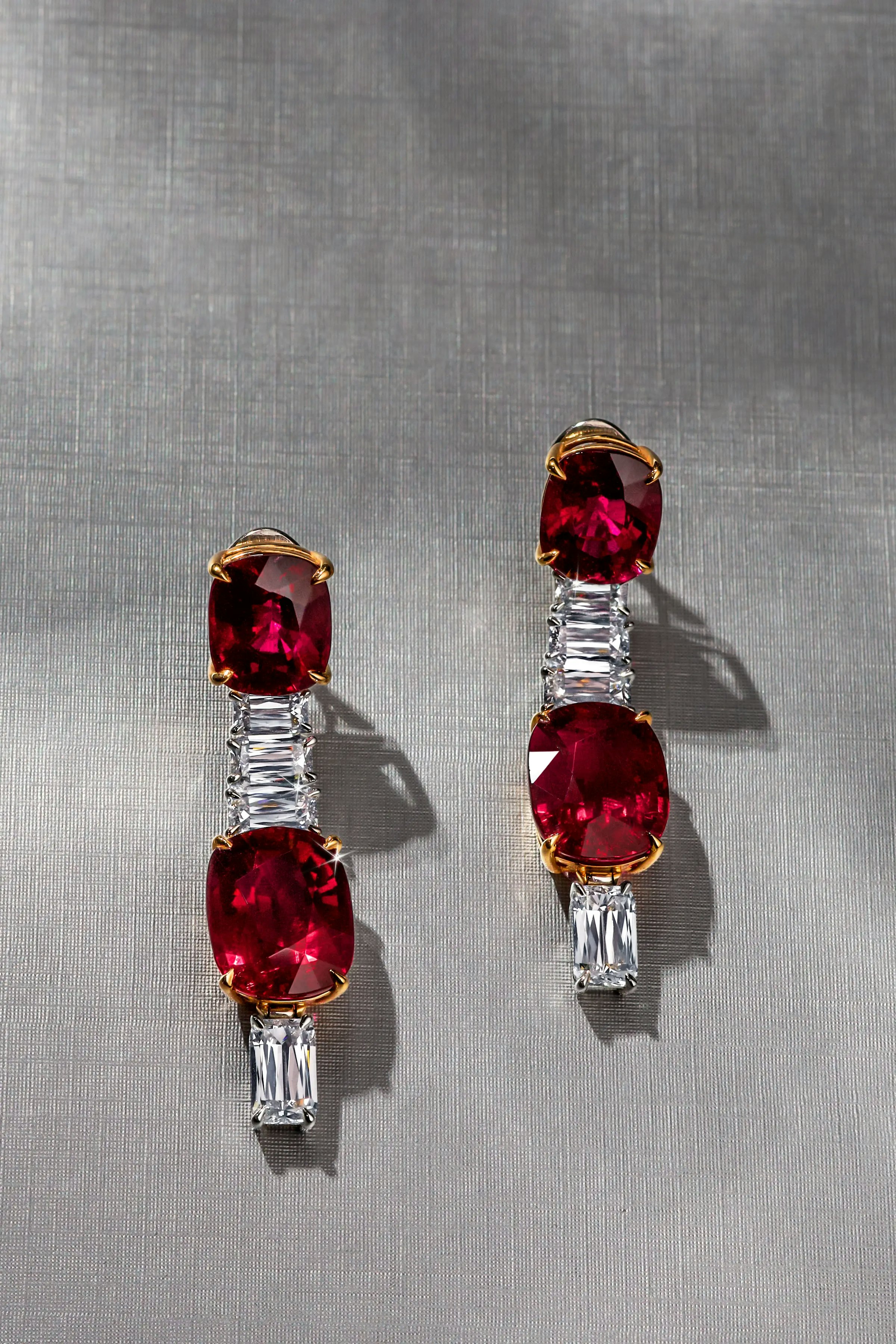 a top-view angle of the earrings laid flat on a gray surface.