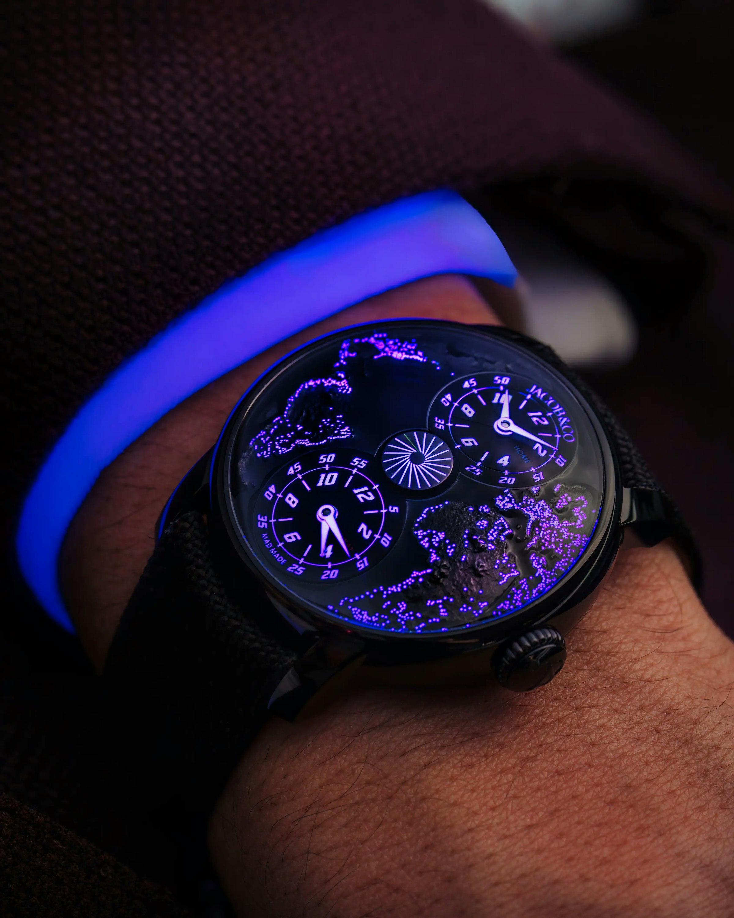the MAD Paris Dual Time Zone watch by night, worn on the left wrist.