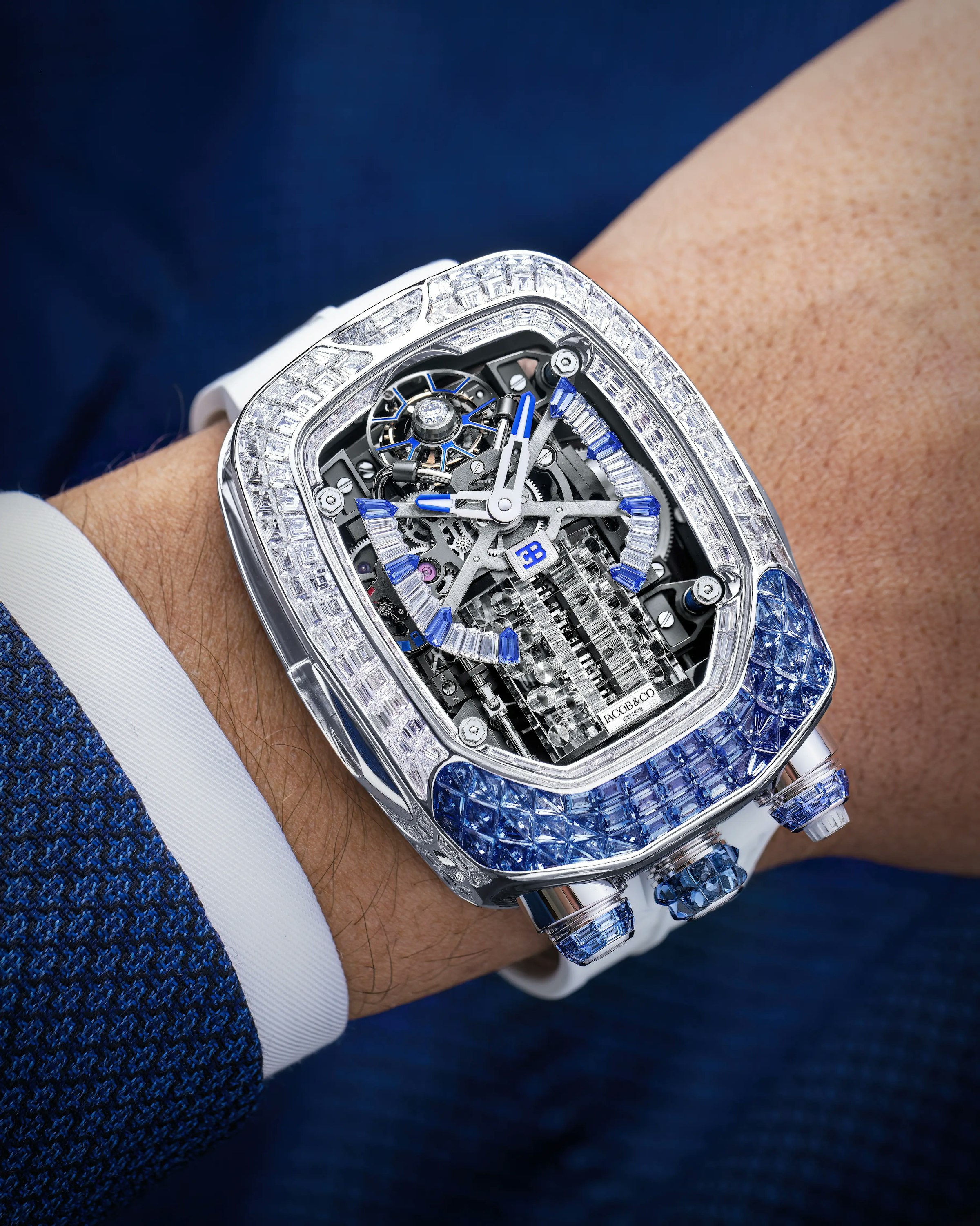 the white diamond and blue sapphire bugatti chiron tourbillon watch, worn on the left wrist