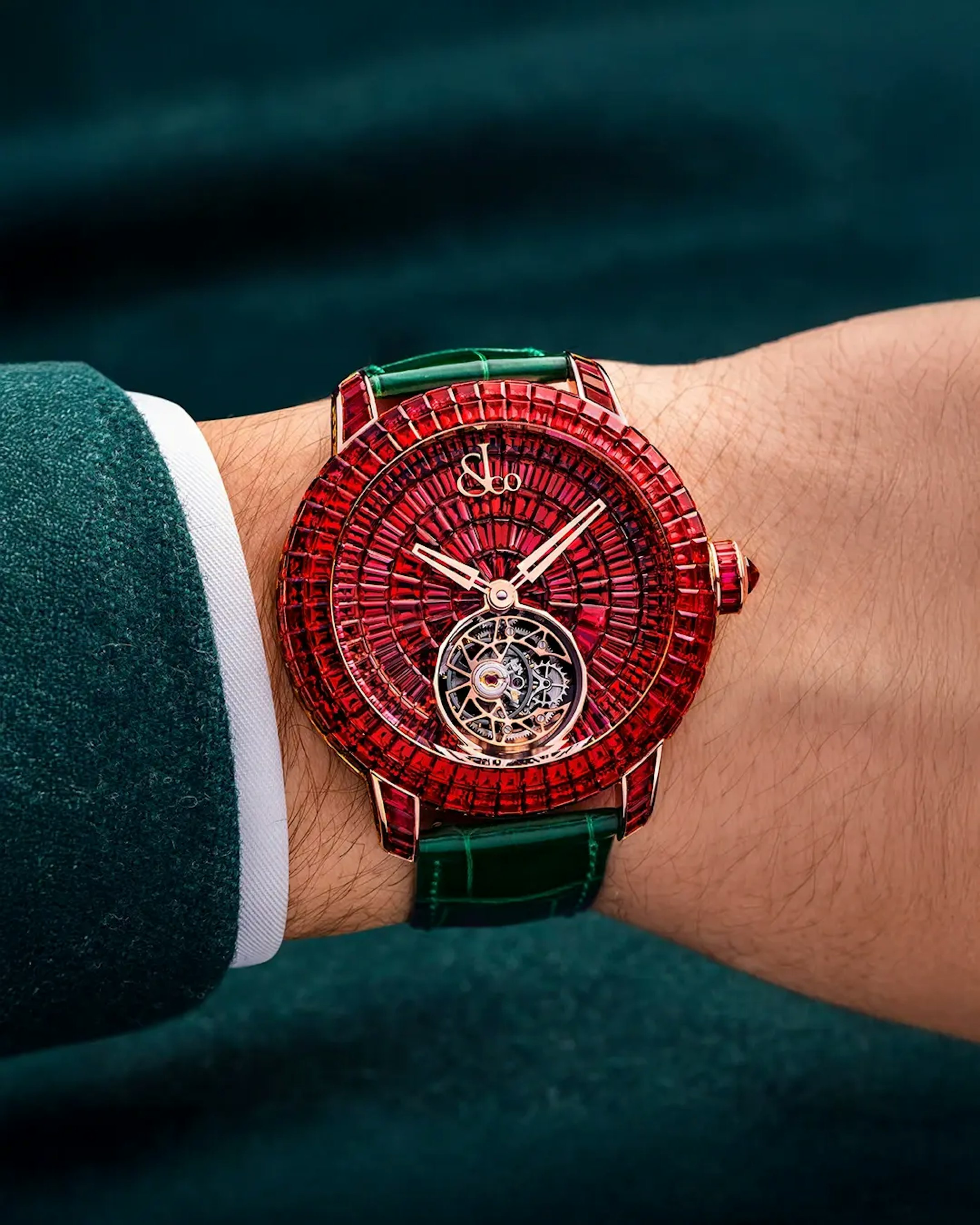 The ruby caviar tourbillon watch, worn on the left wrist