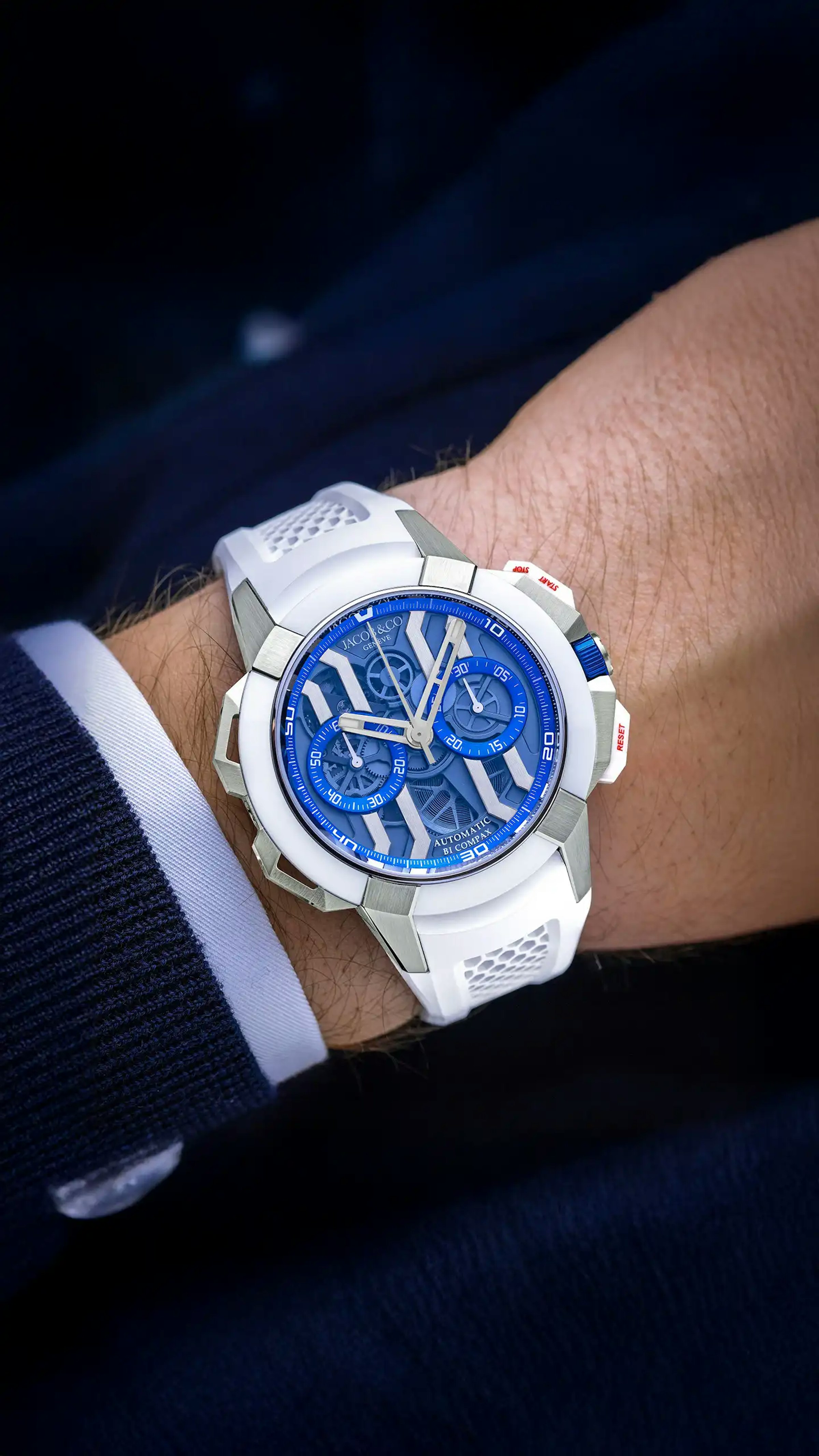 the white epic x chrono 44mm watch with titanium and electric blue accents, worn on the left wrist.