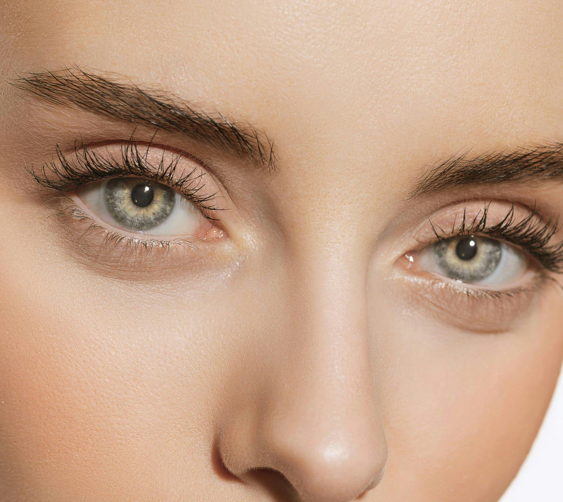 Close up of womans beautiful light green eyes
