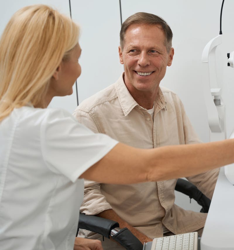 Staff talking to a male patient