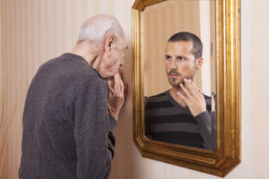 Older Man Seeing Younger Reflection in Mirror
