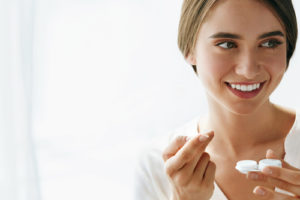 Woman using contact lenses