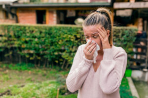 woman holding tissue to her face 