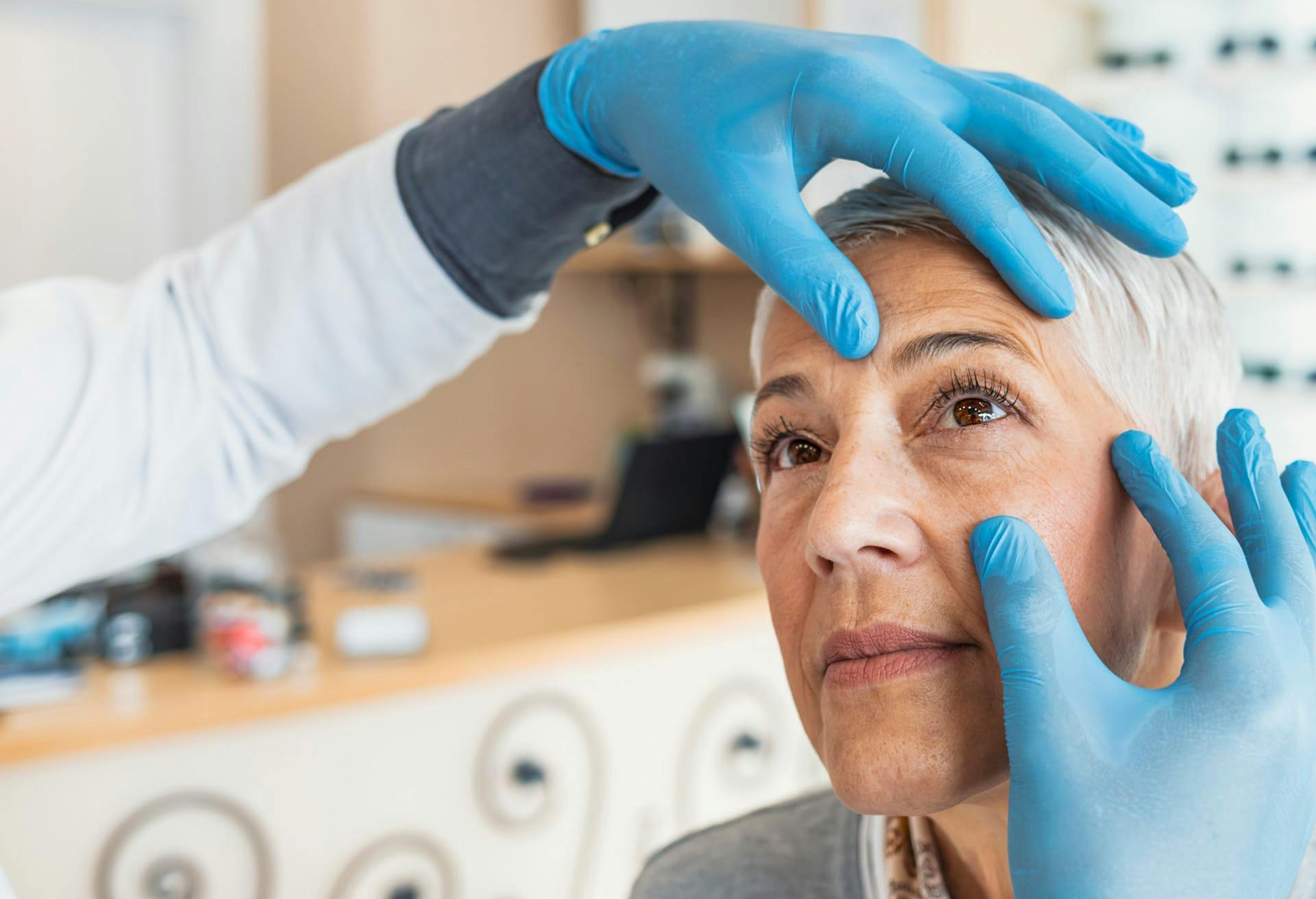 woman getting eyes examined