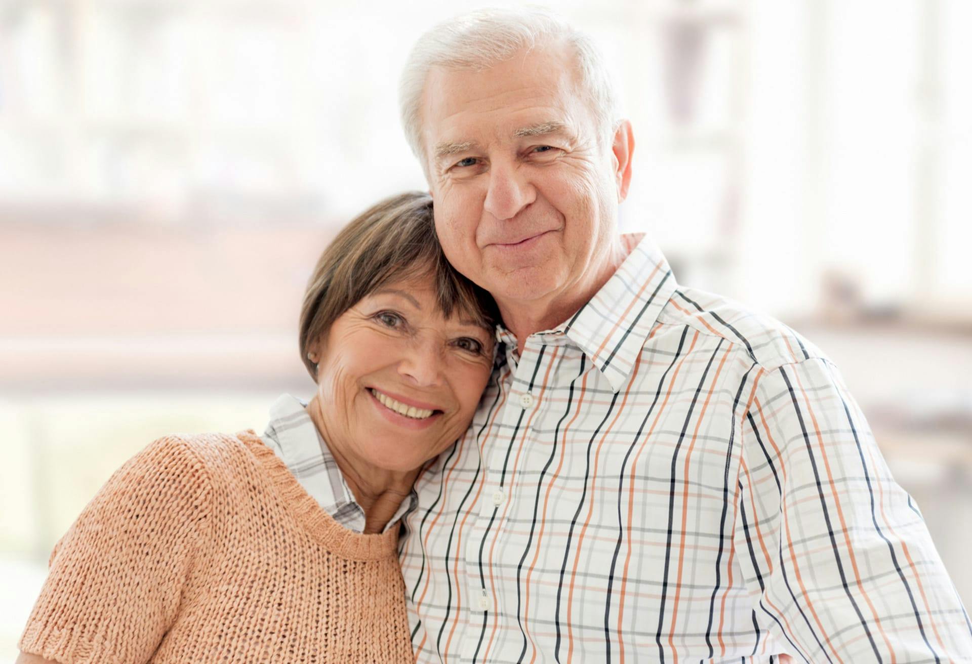 older couple posing next to each other