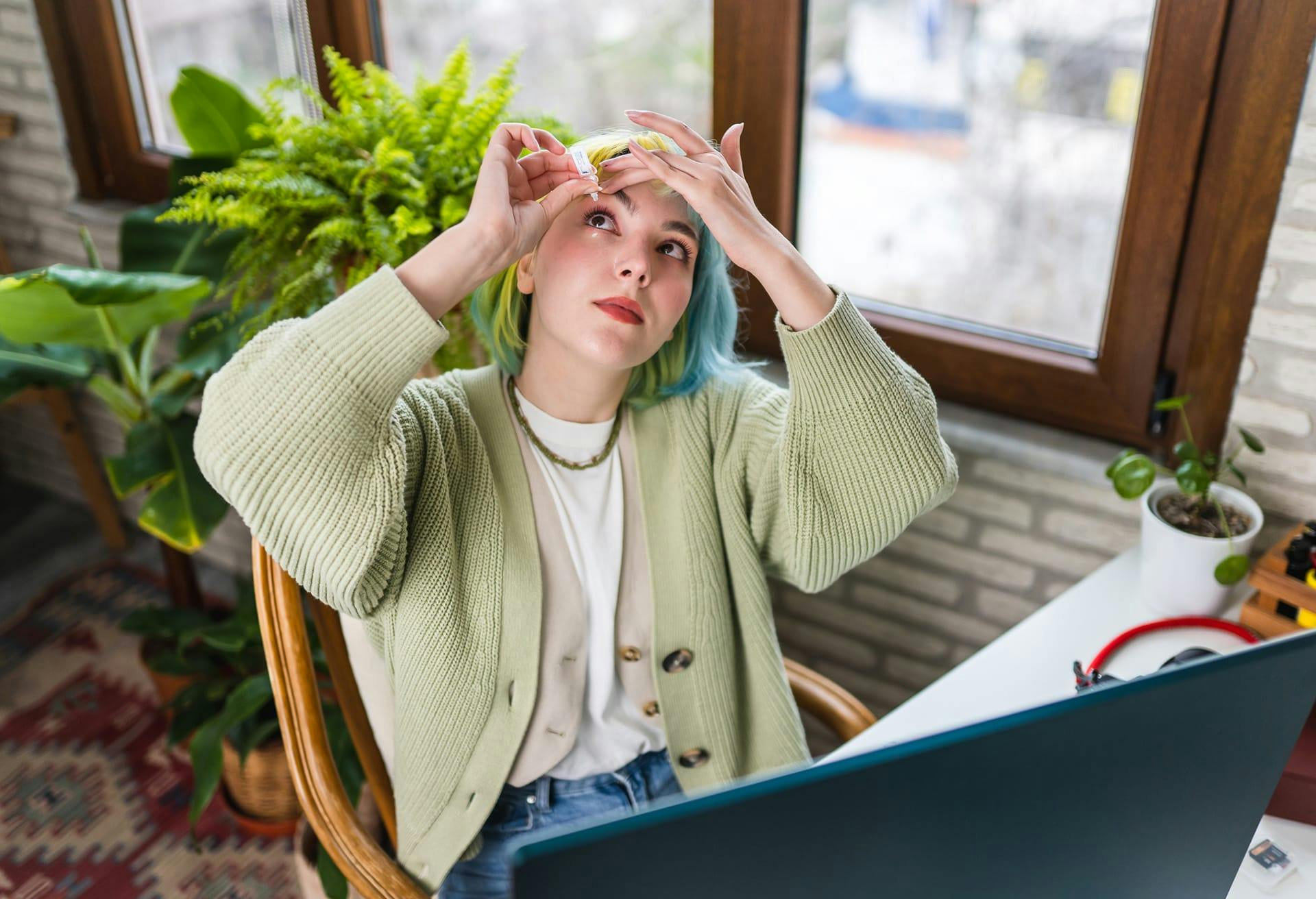 woman putting in eye drops