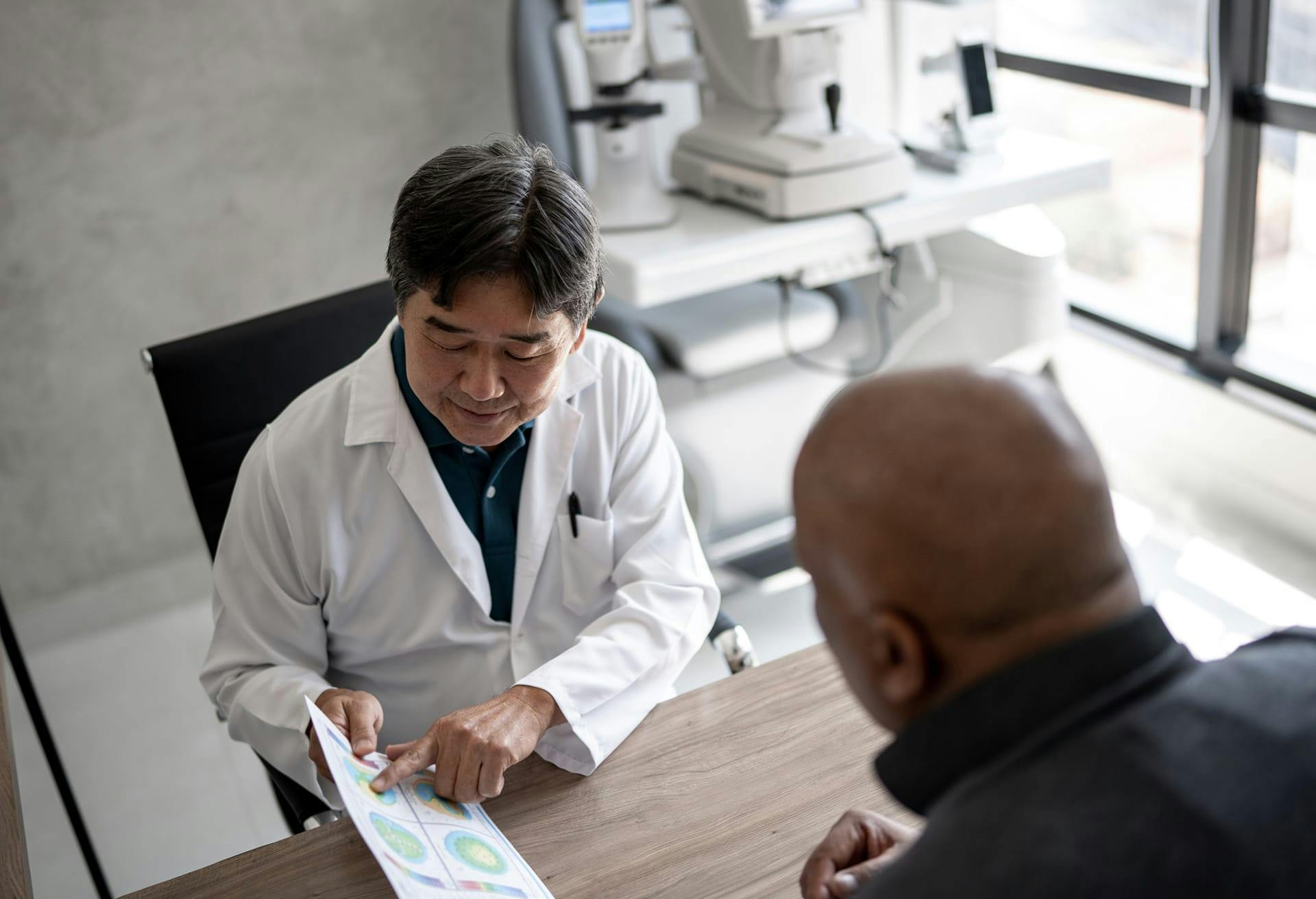 eye doctor and patient speaking