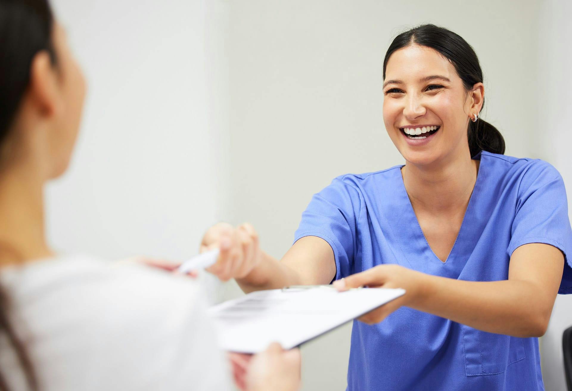 medical staff handing patient paperwork