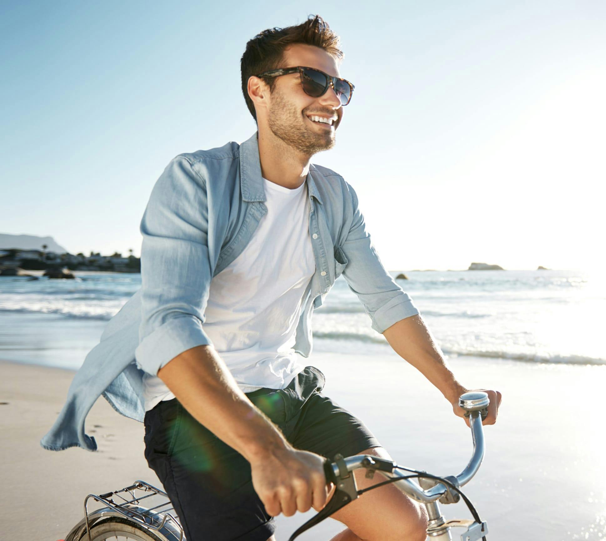 man on a bike at the beach