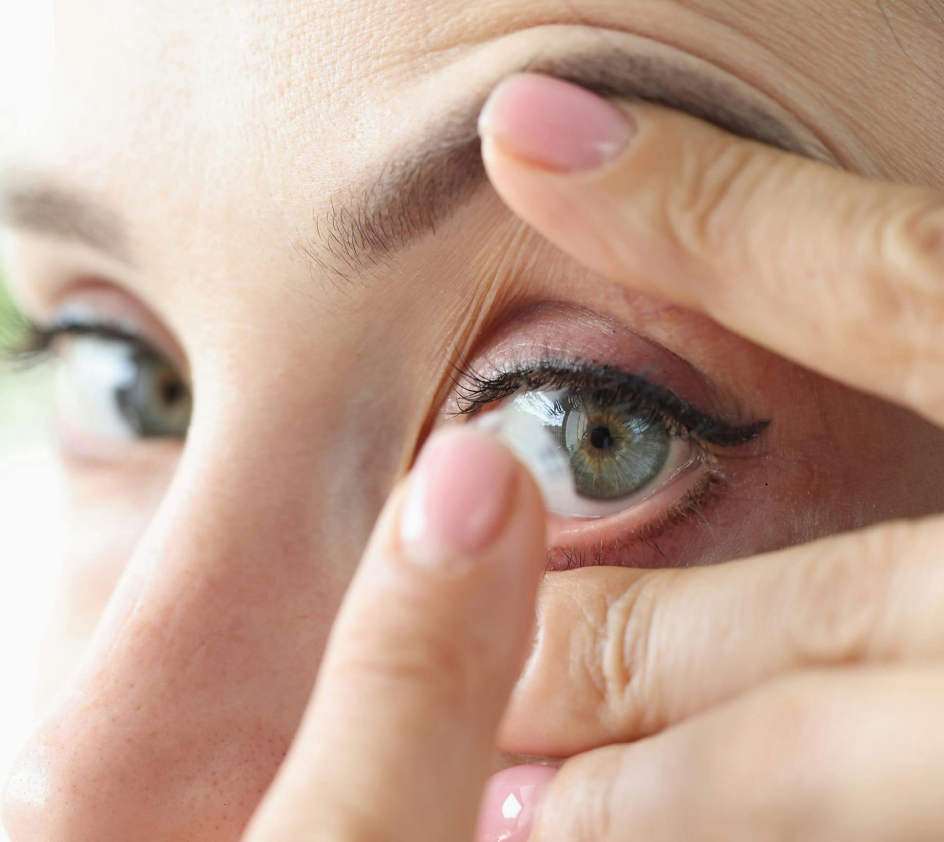 woman putting in contact