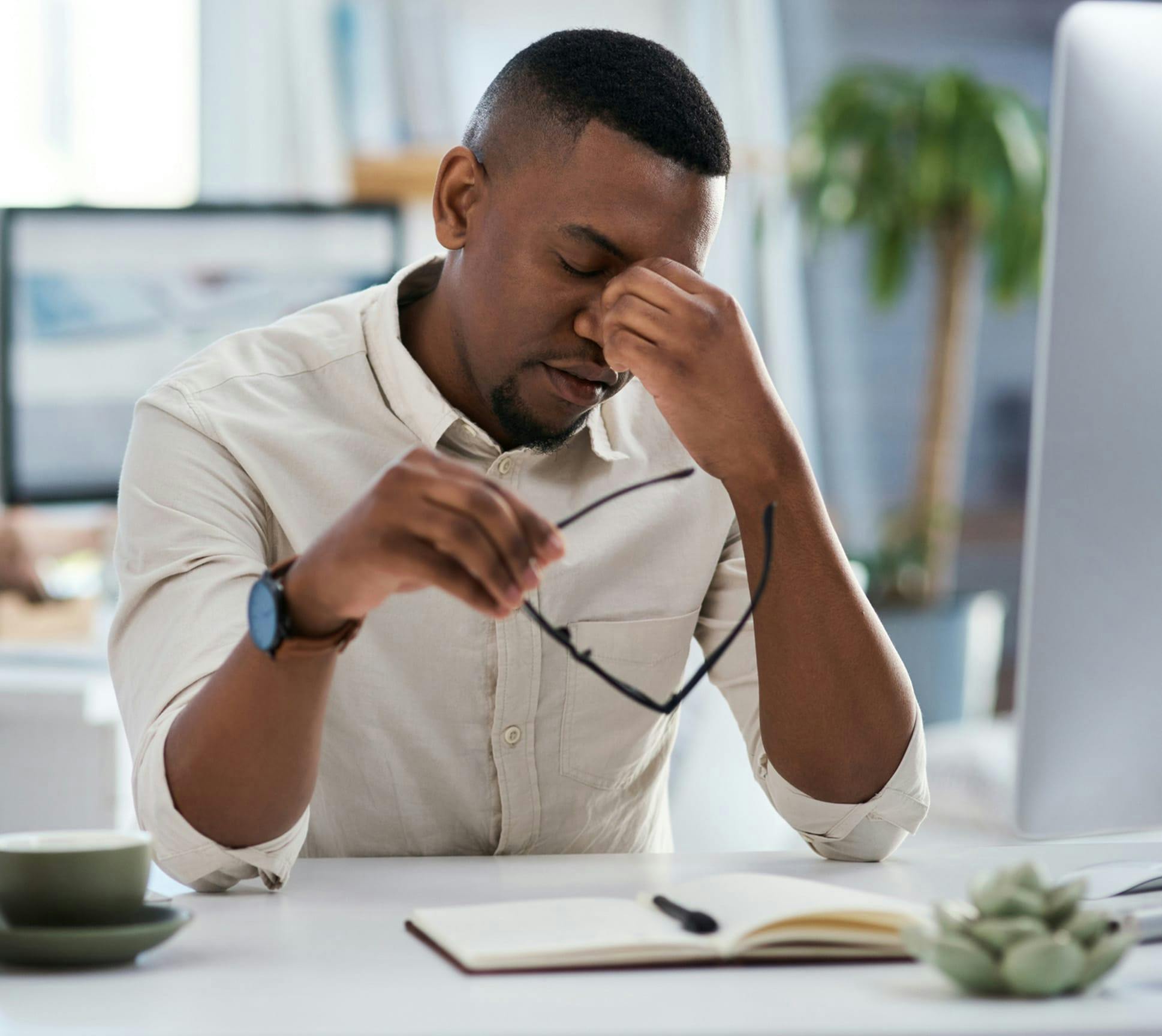 man rubbing his eyes in discomfort