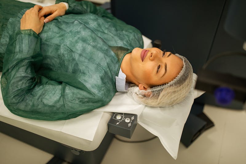 woman lying on table prepped to have LASIK surgery