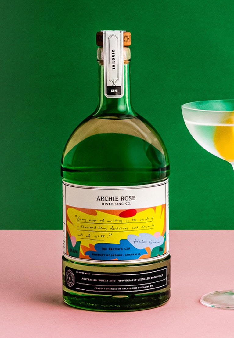 Archie-Rose-The-Writer's-Gin-bottle-next-to-a-martini-with-a-lemon-twist